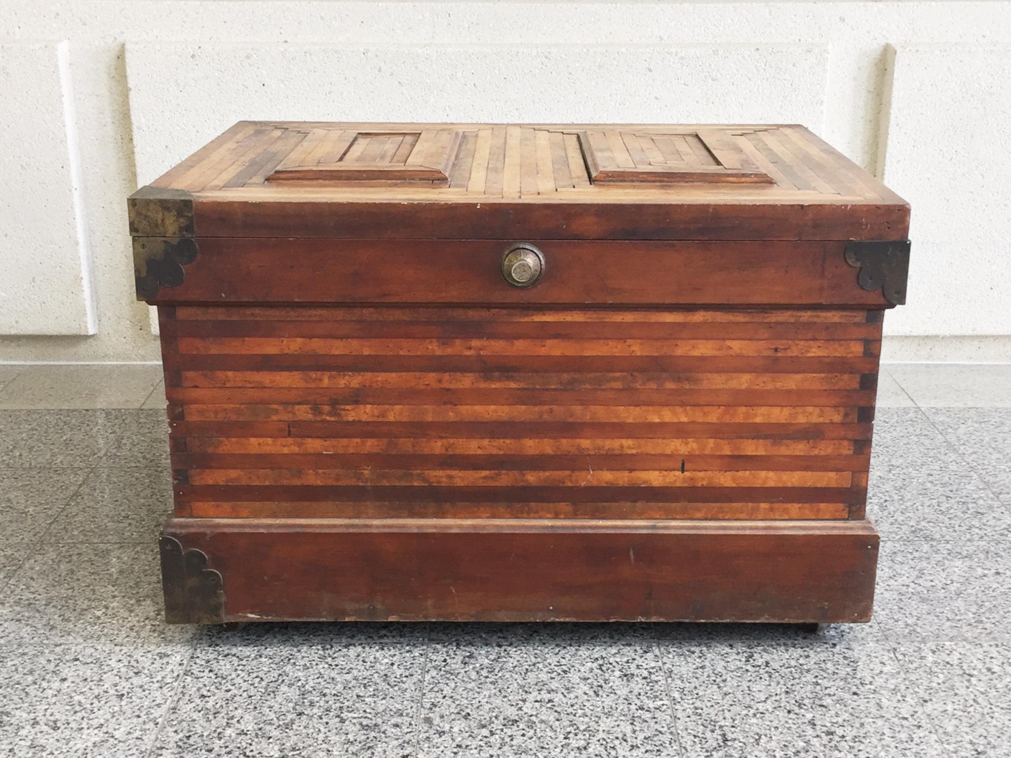 A 19th century trunk expertly crafted with a beautiful parquetry design. The parquetry of the trunk's hinged lid is comprised of two sets of concentric rectangles set side by side, culminating in a raised center with an ogee bevel. Two-toned wood in