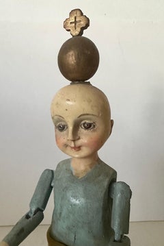 19th Century wood Santos of a boy/child with glass eyes and articulated arms.