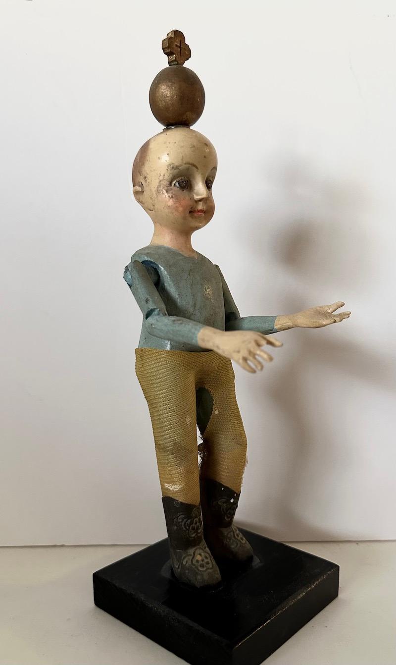 Mexican 19th Century wood Santos of a boy/child with glass eyes and articulated arms. For Sale