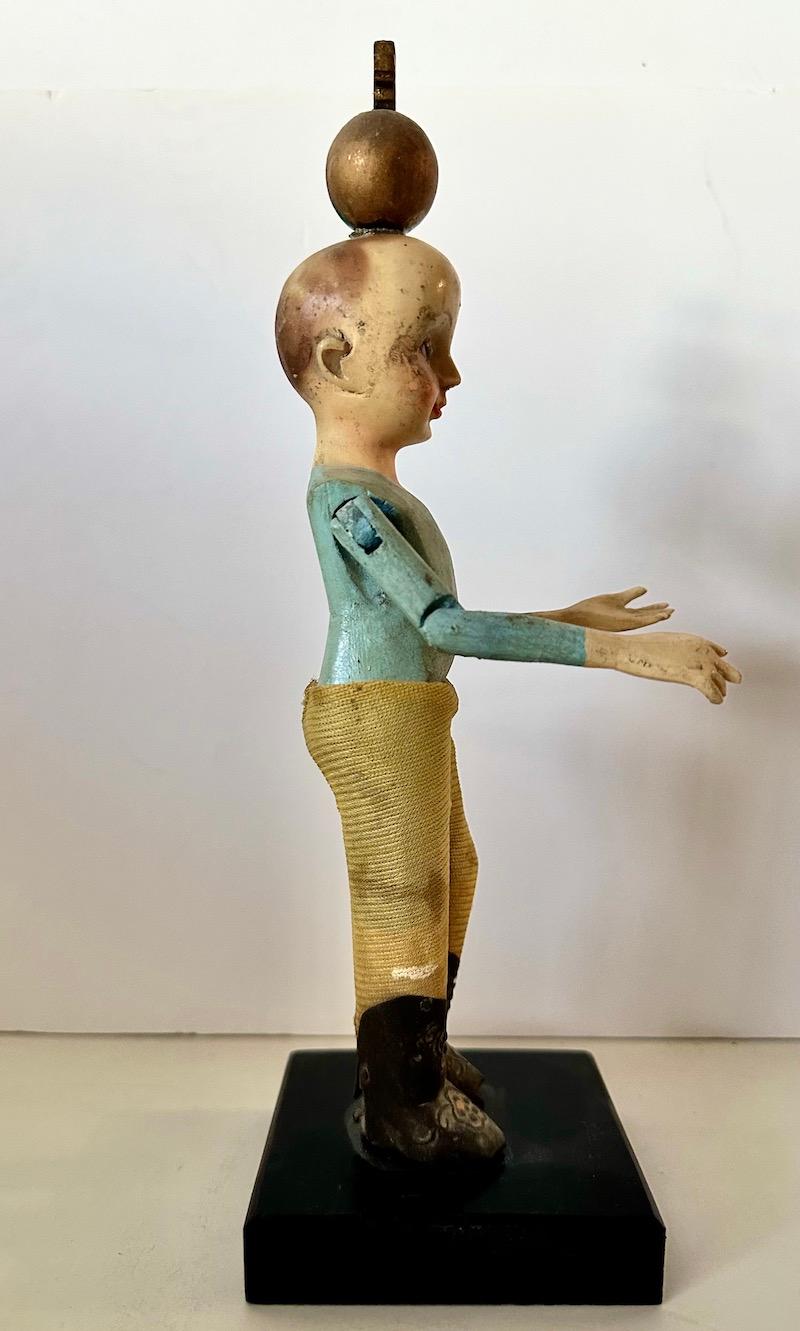Hand-Carved 19th Century wood Santos of a boy/child with glass eyes and articulated arms. For Sale