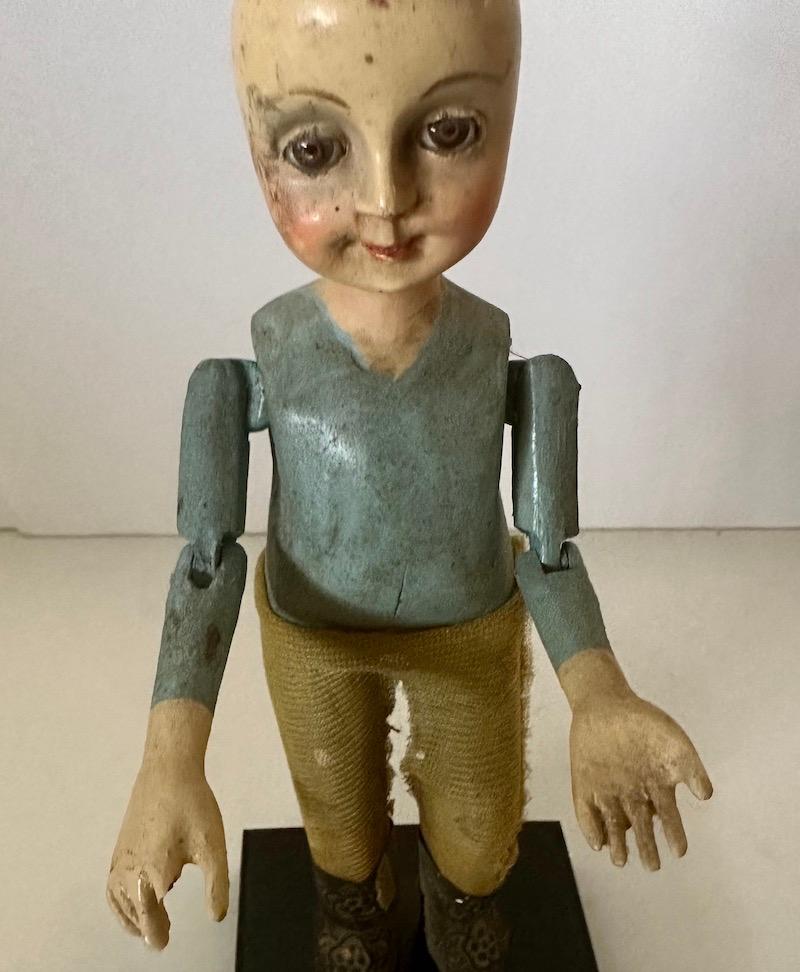 19th Century wood Santos of a boy/child with glass eyes and articulated arms. For Sale 1