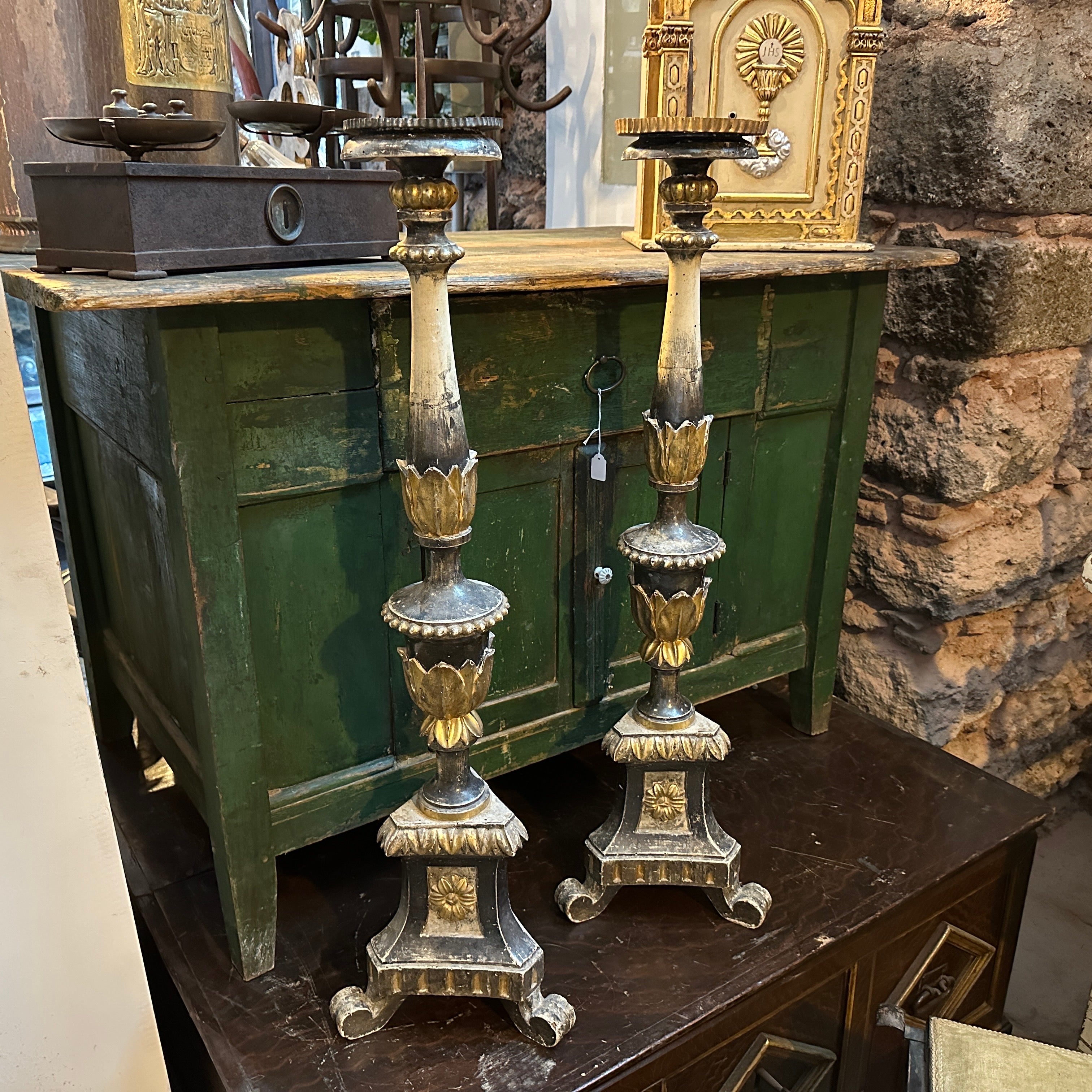 A pair of antique black, white and gilded wood torcheres, they came form a little church inside a prestigious villa in Sicily, they are in original conditions never restored. These torcheres are grand and impressive, displaying the craftsmanship of