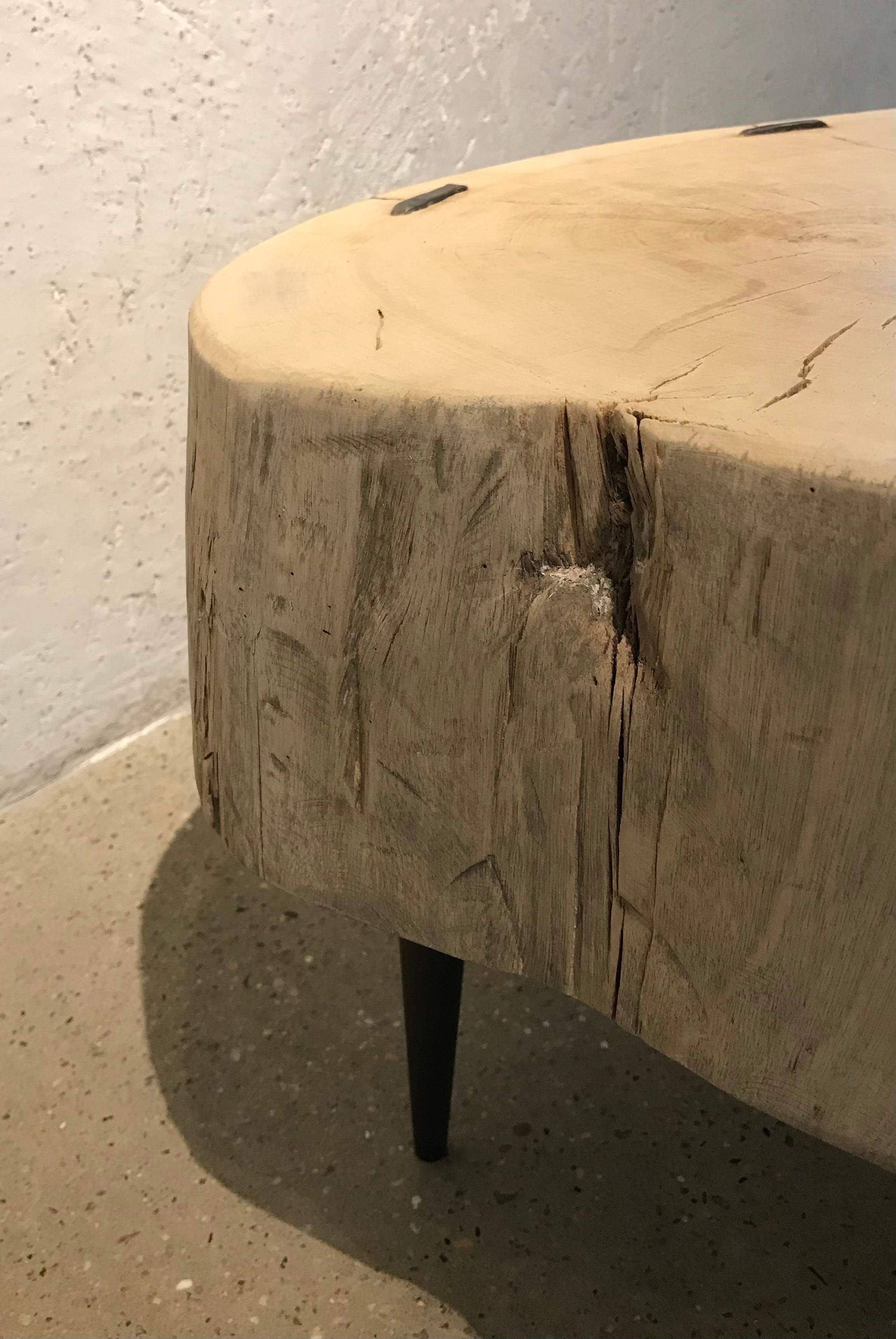 This gorgeous thick, tree trunk slab has been bleached and fabricated into a chic modern style table (coffee, side or cocktail) using hadn't forged iron staples and legs. Slab from China.