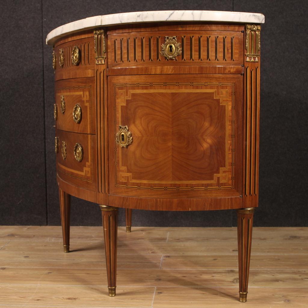 Antique French half moon commode from the second half of the 19th century. Napoleon III furniture veneered in rosewood, palisander, maple, ebonized wood, walnut and fruitwood of excellent quality. Dresser equipped with three central drawers, two