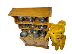 19th Century wooden dollhouse cabinet filled with pewter and bear