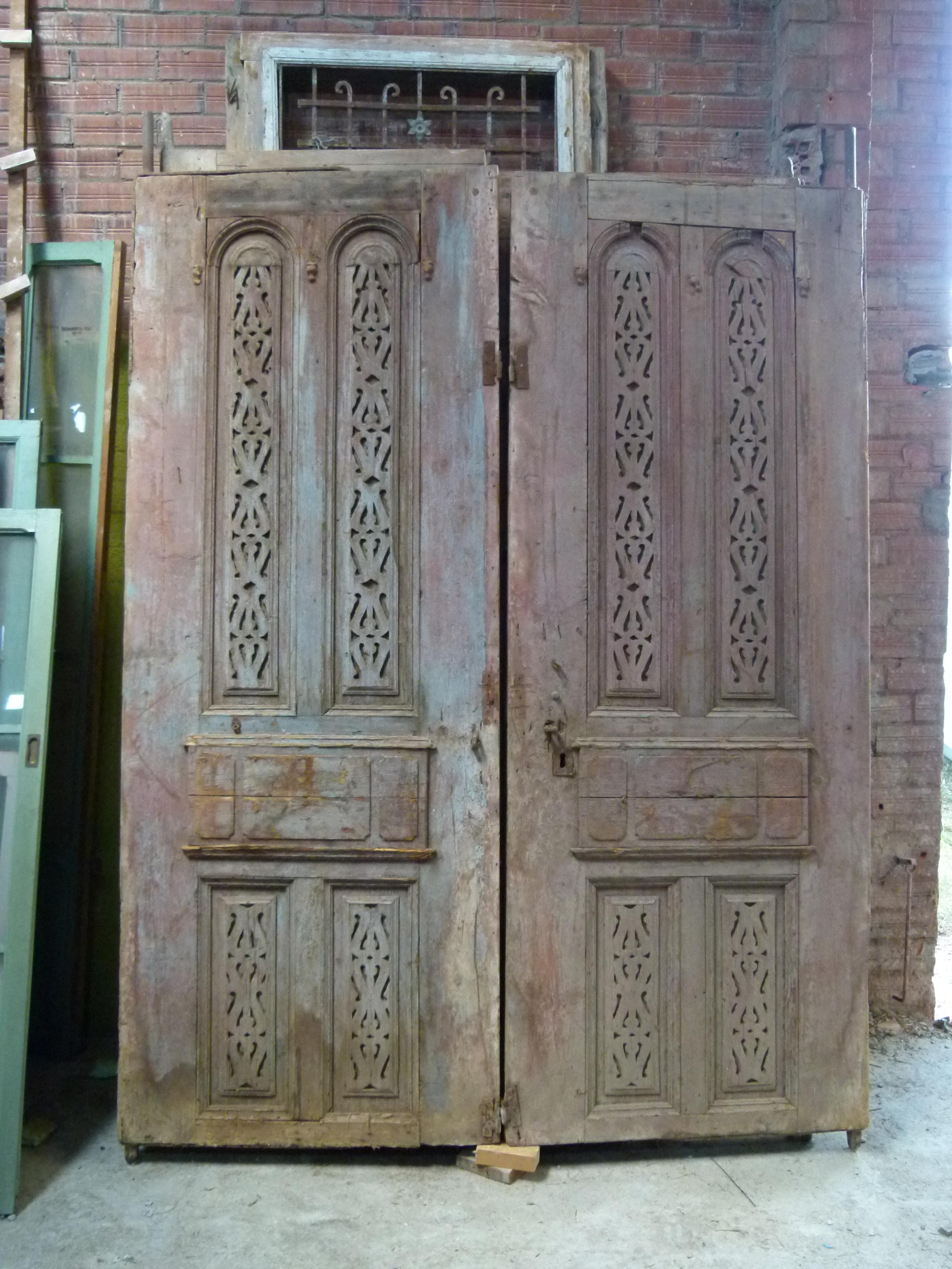 19th century wooden double door portal in Art Nouveau style from Catalonien, Spain.
Each door has 2 lateral pivots to be embedded in the stone.
The original patina of this Portal and its style will give the necessary charm to your building or