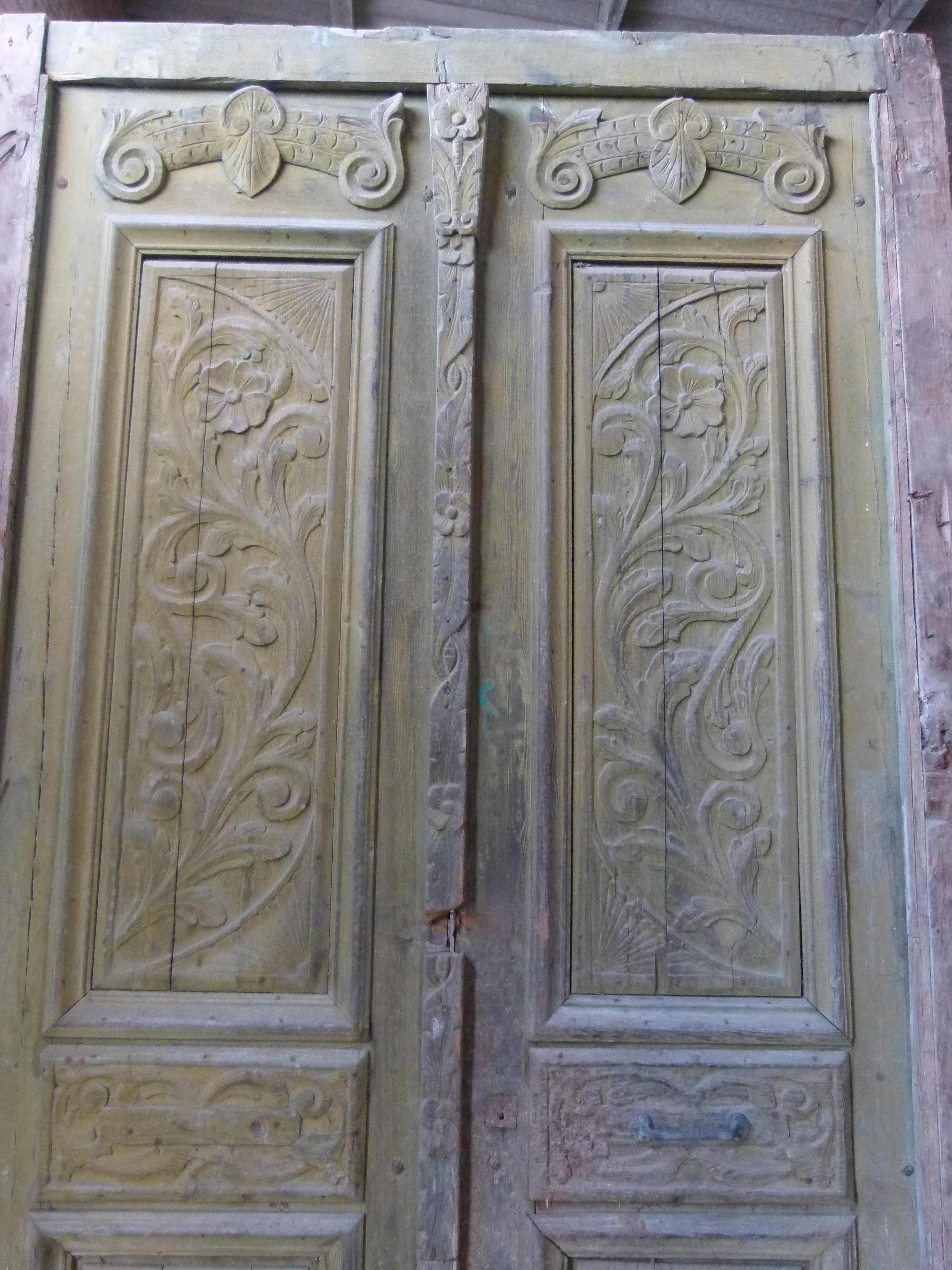 19th century double front door with patina in Art Nouveau style from Catalonien, Spain.
 Carved wood from this period.
The door is framed and working but needs some restoration as some parts are damaged.
The original patina of the door and its