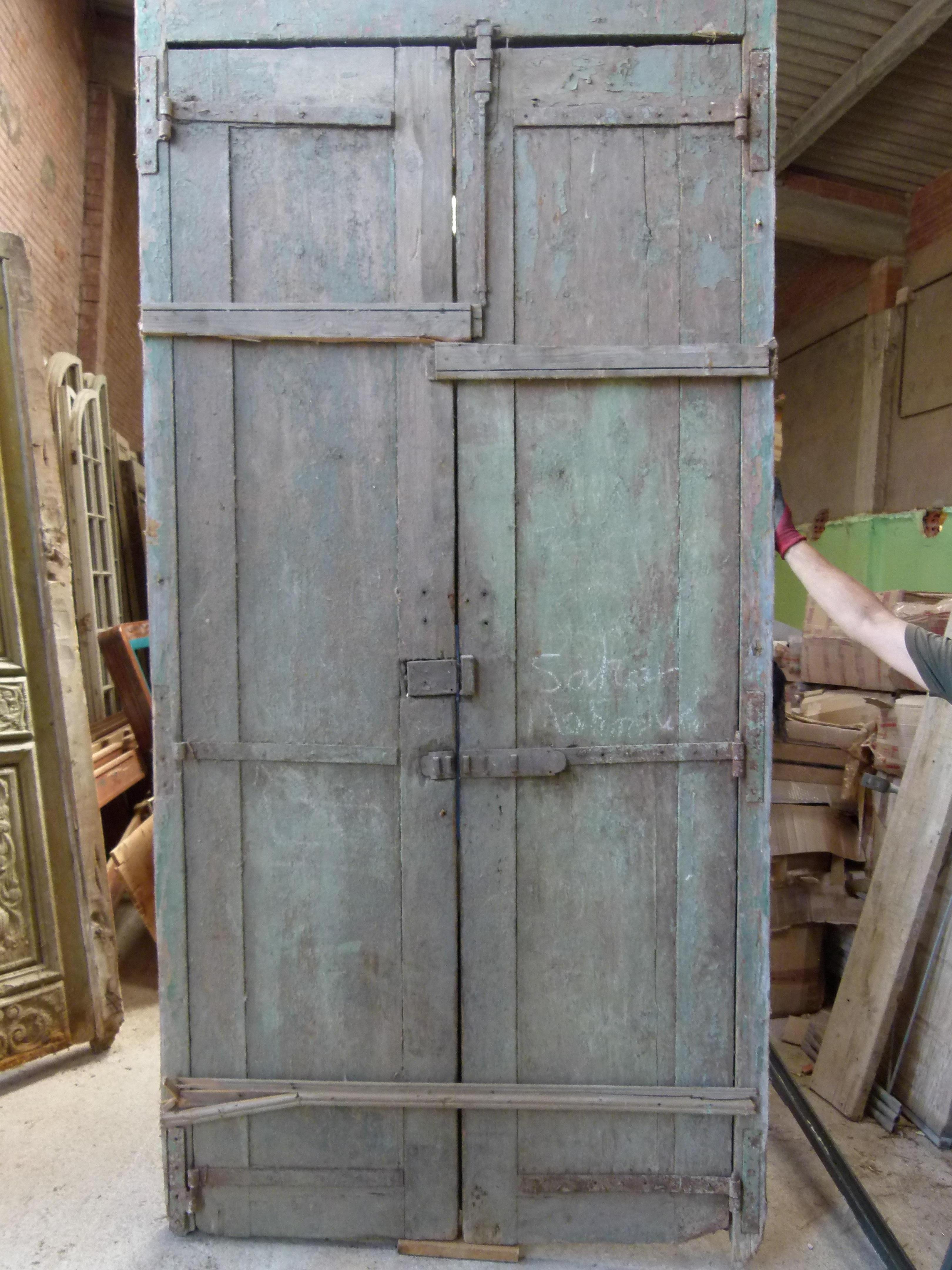 19th century double wooden front door with patina in Art Nouveau style from Catalonien, Spain.
Carved wood typical from this period.
The door is framed and working but needs some restoration as some parts are damaged.
The original patina of the