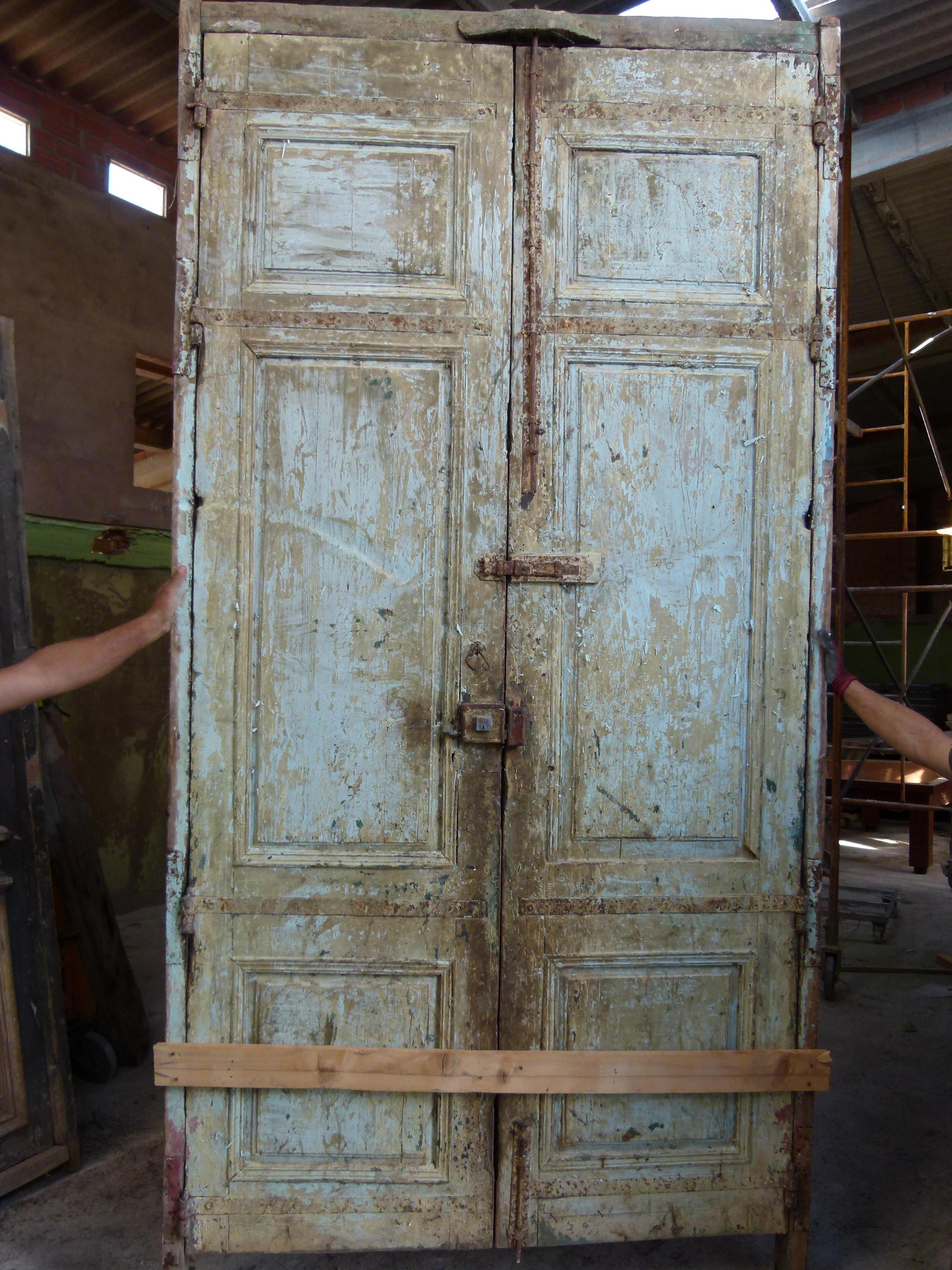 19th century double wooden front door with patina in Art Nouveau style from Catalonian, Spain.
Carved wood typical from this period.
The door is framed and working but needs some restoration as some parts are damaged.
The original patina of the