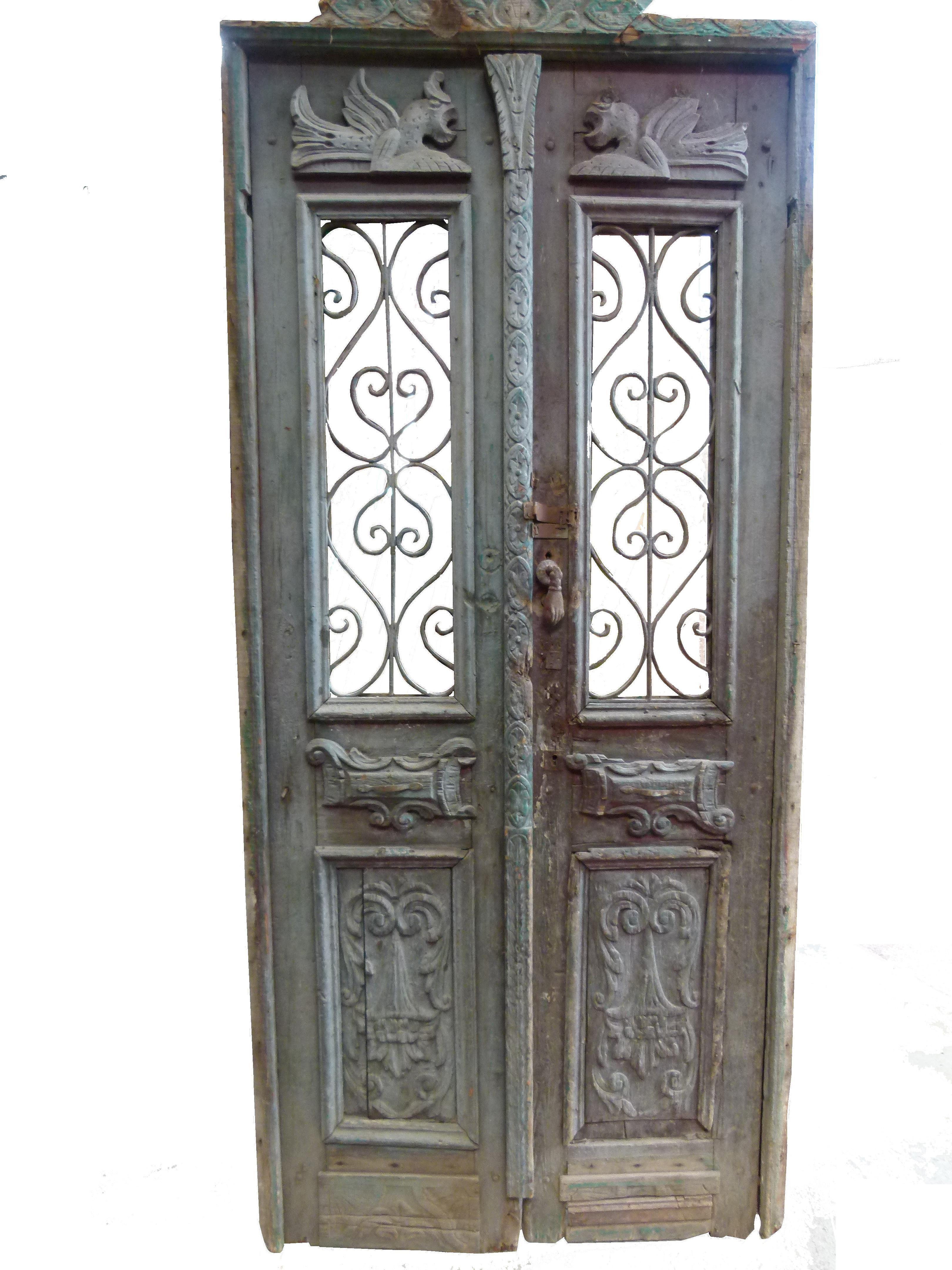 19th century double front door with patina in Art Nouveau style from Catalonien, Spain.
Carved wood and cast iron typical from this period.
The door is framed and working but needs some restoration as some parts are damaged.
The original patina