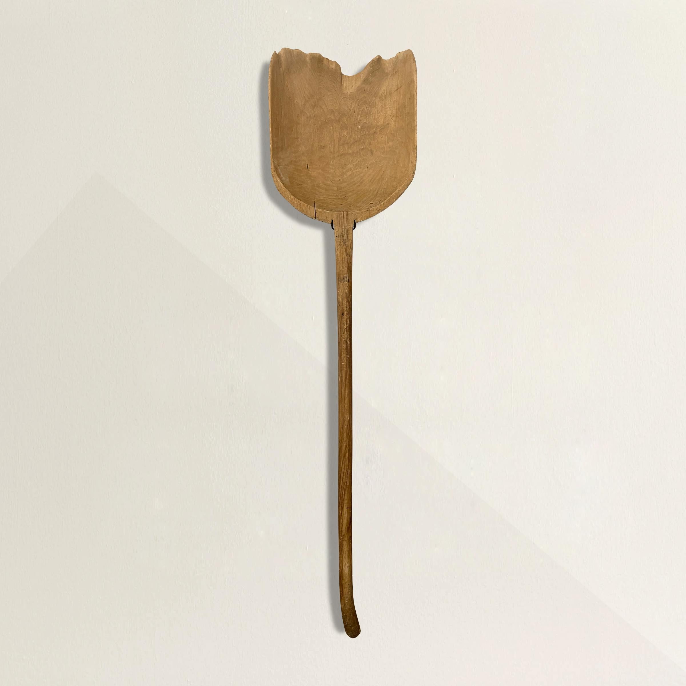 A simple yet honest 19th century hand-carved wood grain shovel with the most wonderful smooth finish only one hundred years of use could bestow, and mounted on a custom steel wall mount so it can be displayed anywhere you wish. Found in Northern