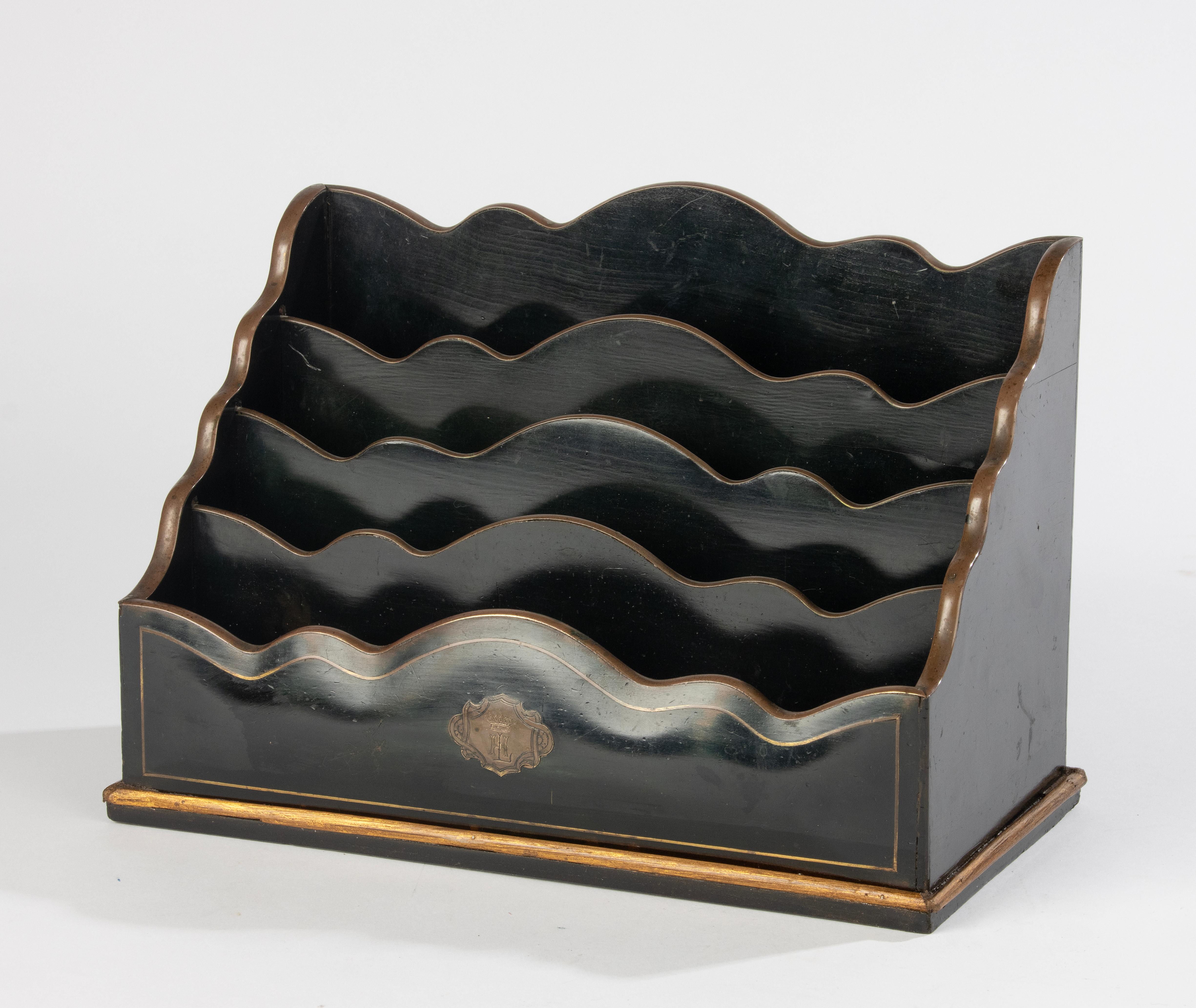 A beautiful antique letter rack, made of Black ebonized wood, with brown patinated brass trims. 
Made in the late Napoleon III period in France, around 1870-1880.
Bombay shaped  front with brass plaque with a monogram H.L.
The letter rack is in very