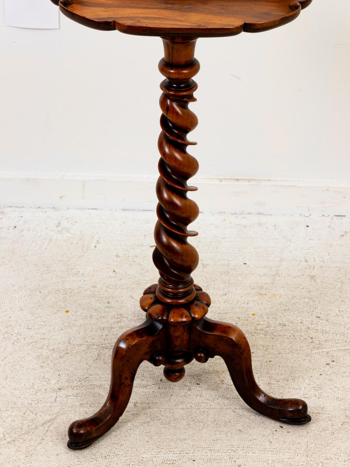 Circa late 18th century walnut work table with snake turned feet. The piece also features tripod legs that support a barley twist central column and a kidney shaped work surface with scalloped trim. On the far side of the kidney shaped tabletop
