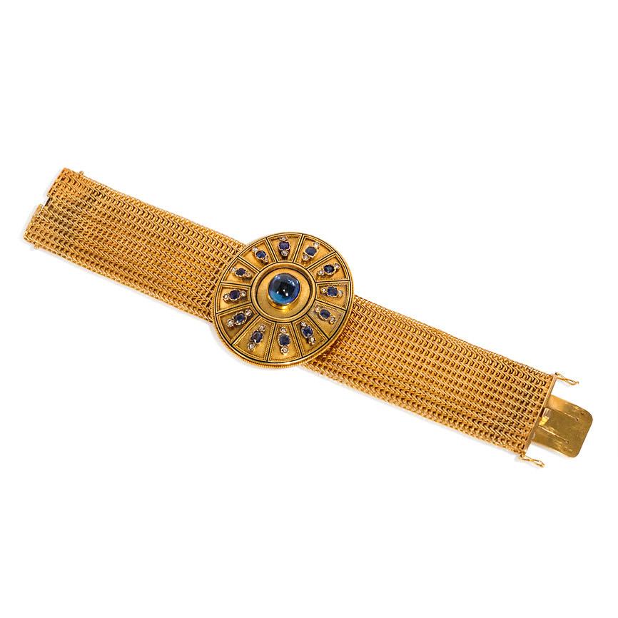 An antique Victorian-period woven gold bracelet centering on a removable oval boss with wirework decoration and set with a central cabochon sapphire additionally surrounded by cushion-cut sapphires and diamonds, in 18k.  France; poinçon for