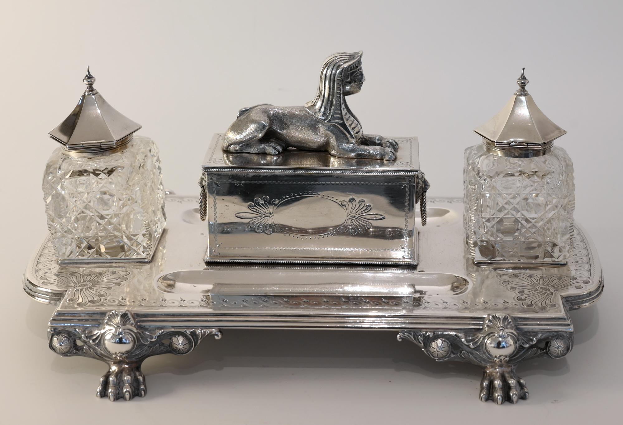 This beautiful writing set was made in Sheffield 1882 and is out of 1450gr. Sterling silver. The maker's mark is JBB. The two inkwells are made out of cut crystal glass.