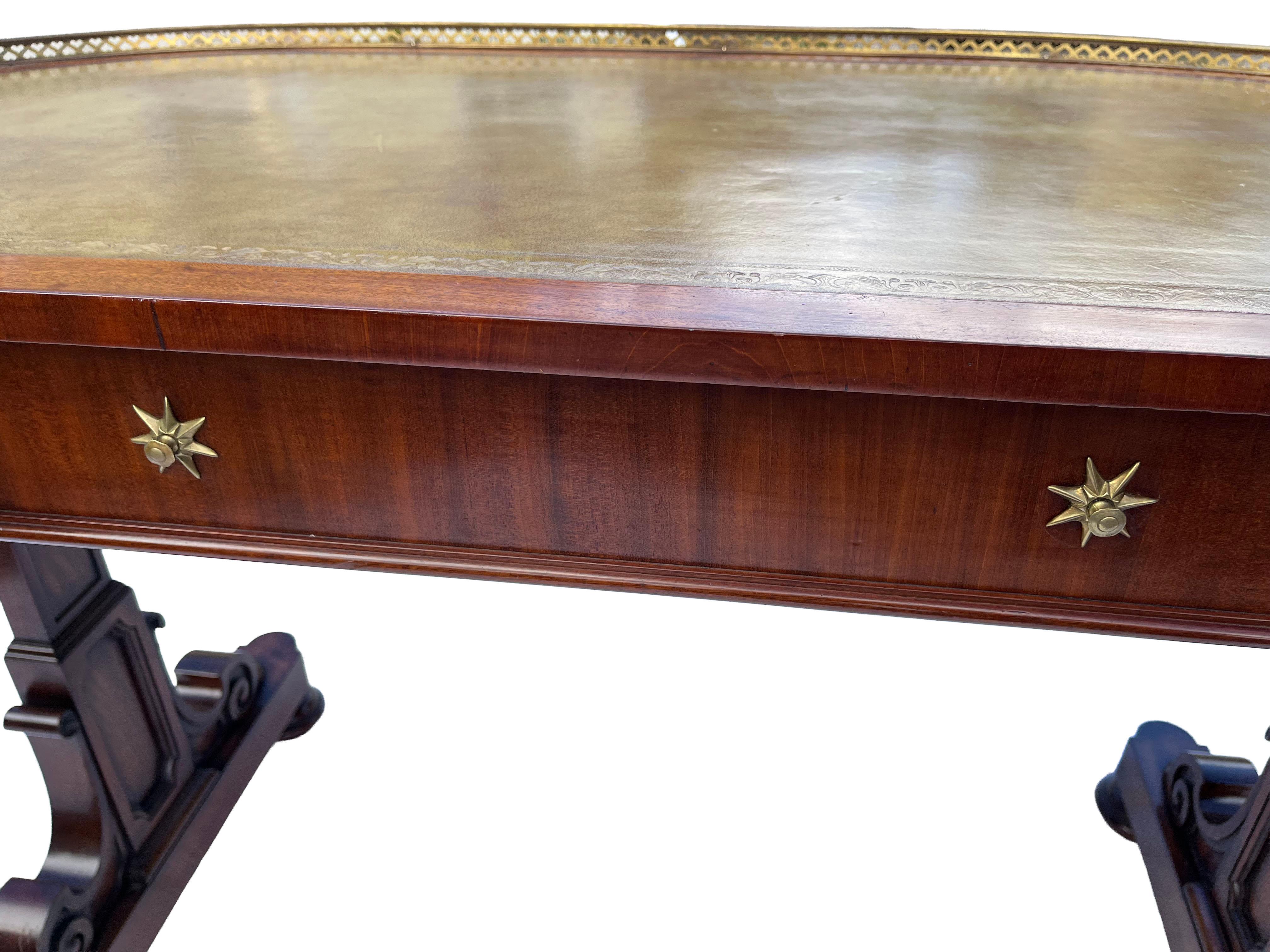 A remarkable 19th-century kidney-shaped mahogany writing table by the esteemed Gillow & Co. is featured. This exquisite piece boasts a brass gallery rail encircling the top edge and a tooled green leather writing surface. A central drawer is adorned