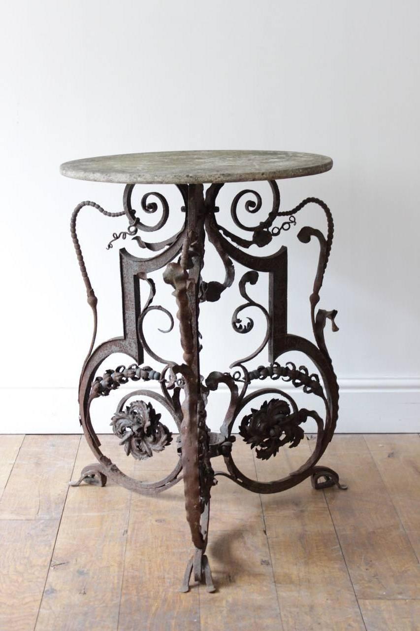 A late 19th century French wrought iron occasional table with a marble top of unusual design, that would work well outdoors or in a conservatory. 

France, circa 1880-1900.
 