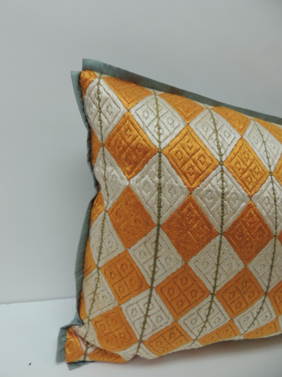 Throw pillow handcrafted with an artisanal Indian Phulkari textile exhibiting a yellow and ecru diamond patterns motif. The Phulkari artisanal antique textile was handmade with embroidered silk floss threads stitched onto linen. Throw pillow further