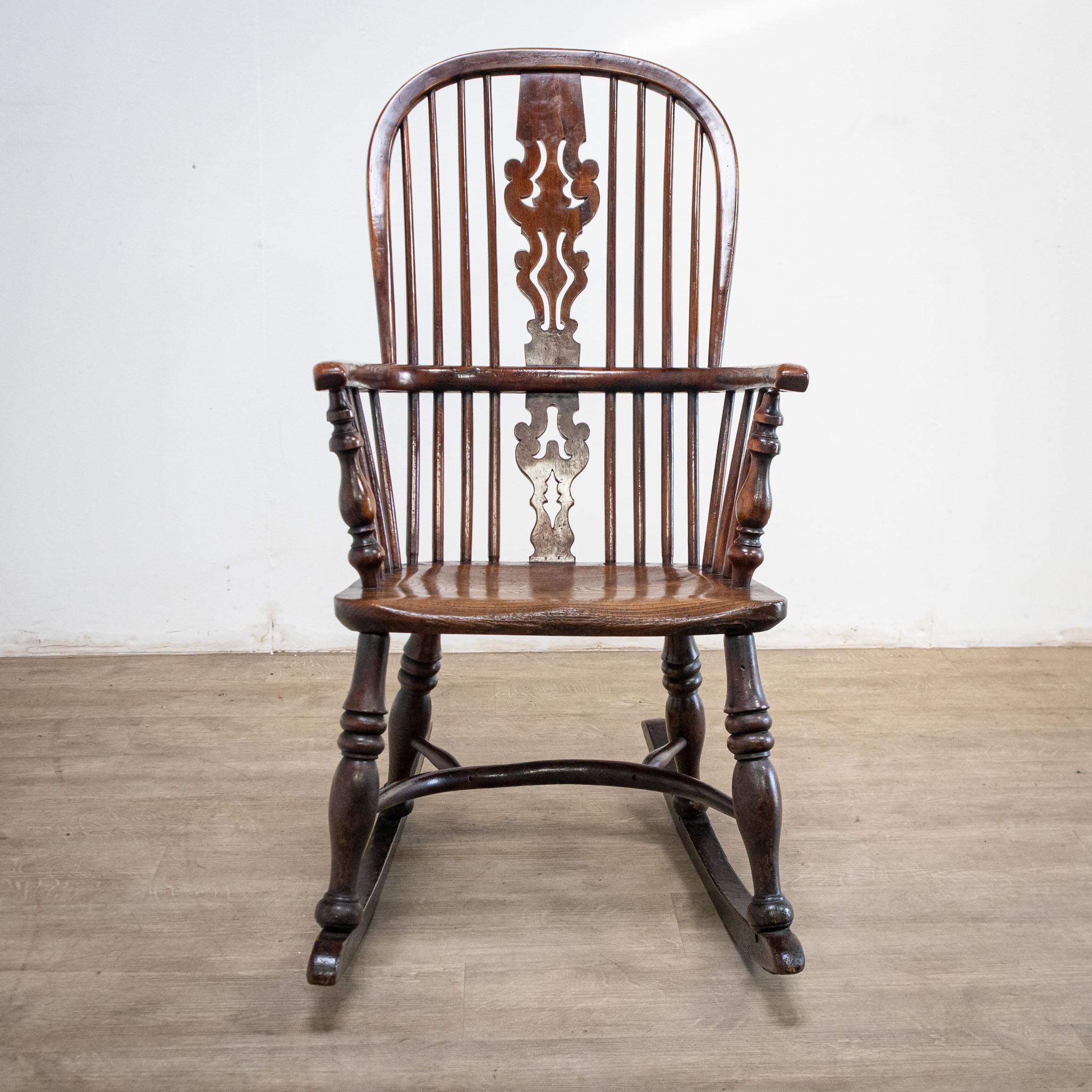 An attractive 19th century chair of yew, this has the appearance of a Windsor chair on a rocking base, with lovely tactile bentwood arms and a pierced splat. It has an incised stamp for the maker, J. Spencer, on the side of the seat.

- Decorative