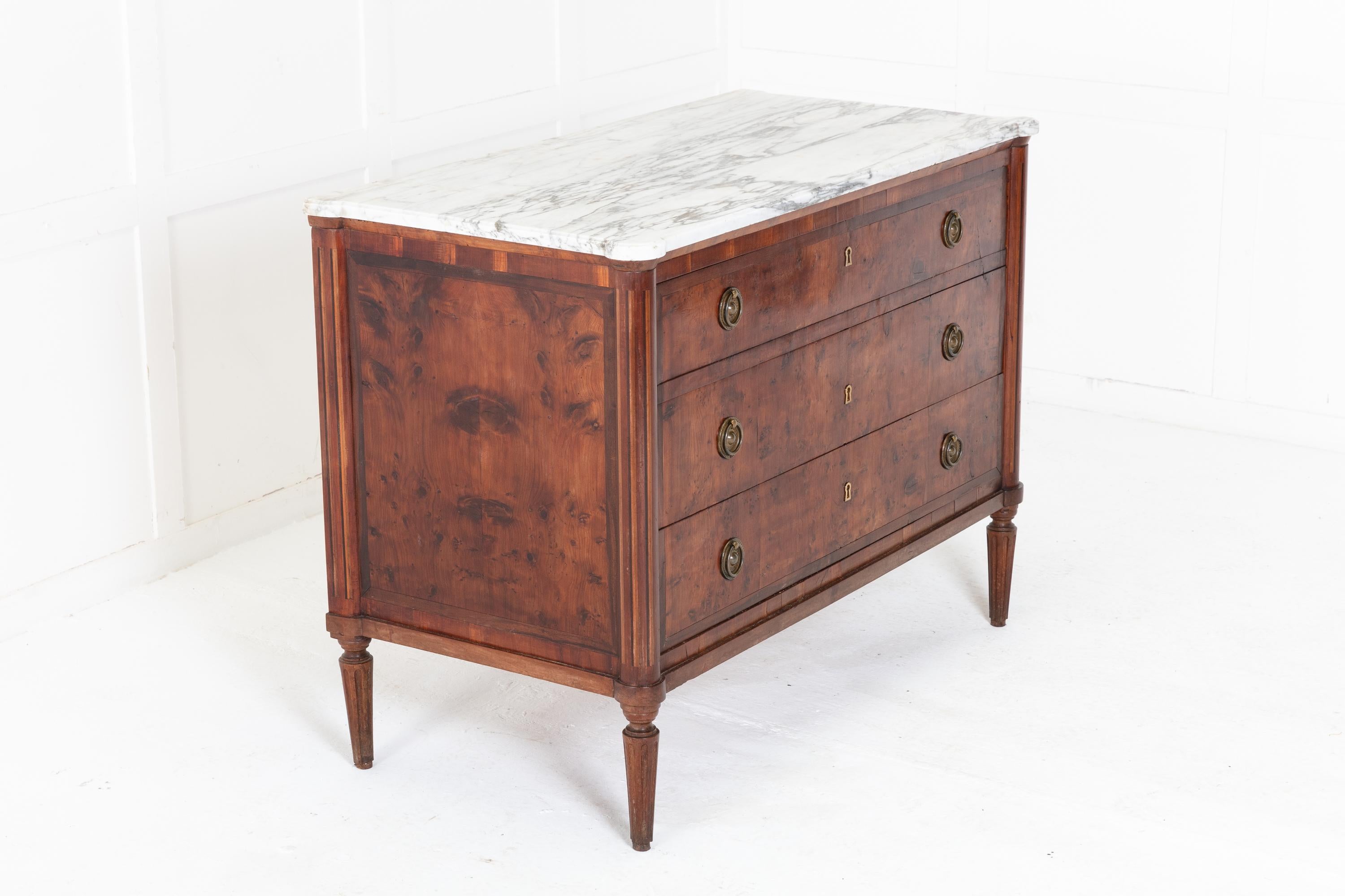 An unusual, early 19th Century yew, secretaire commode. Having a white and grey marble top above the secretaire drawer. The front of the top drawer is lowered by a latch mechanism and opens to reveal a compartment, small drawers and a writing