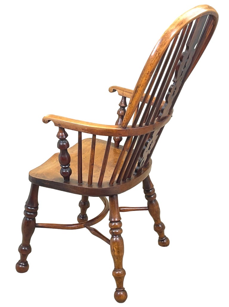 A very attractive and good quality mid 19th century high back yew wood Windsor armchair having elegant Christmas tree type pierced splat and well figured elm seat raised on turned legs united by crinoline stretcher.

The humble windsor chair in