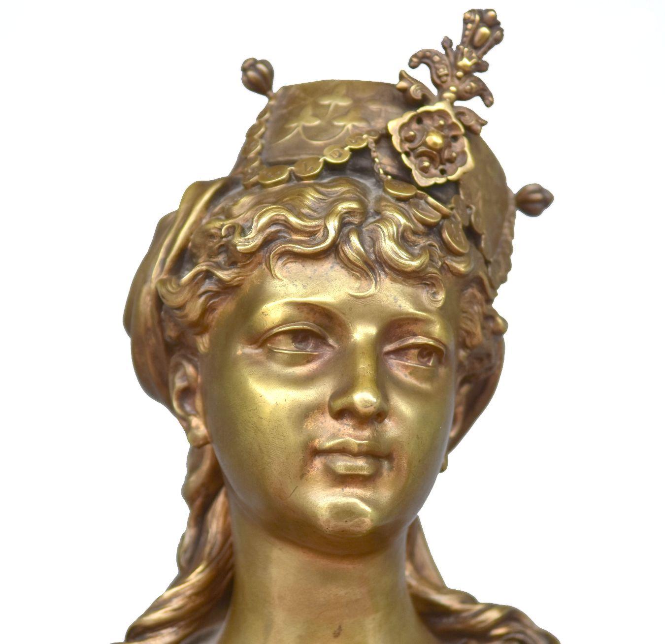Bronze bust Young oriental women illegible inscription she wears a headdress decorated with clovers and pearls very high quality of carving dimension 52 cm high by 30 cm wide and 18 cm deep. Work to be compared to that of Charles Cordier.