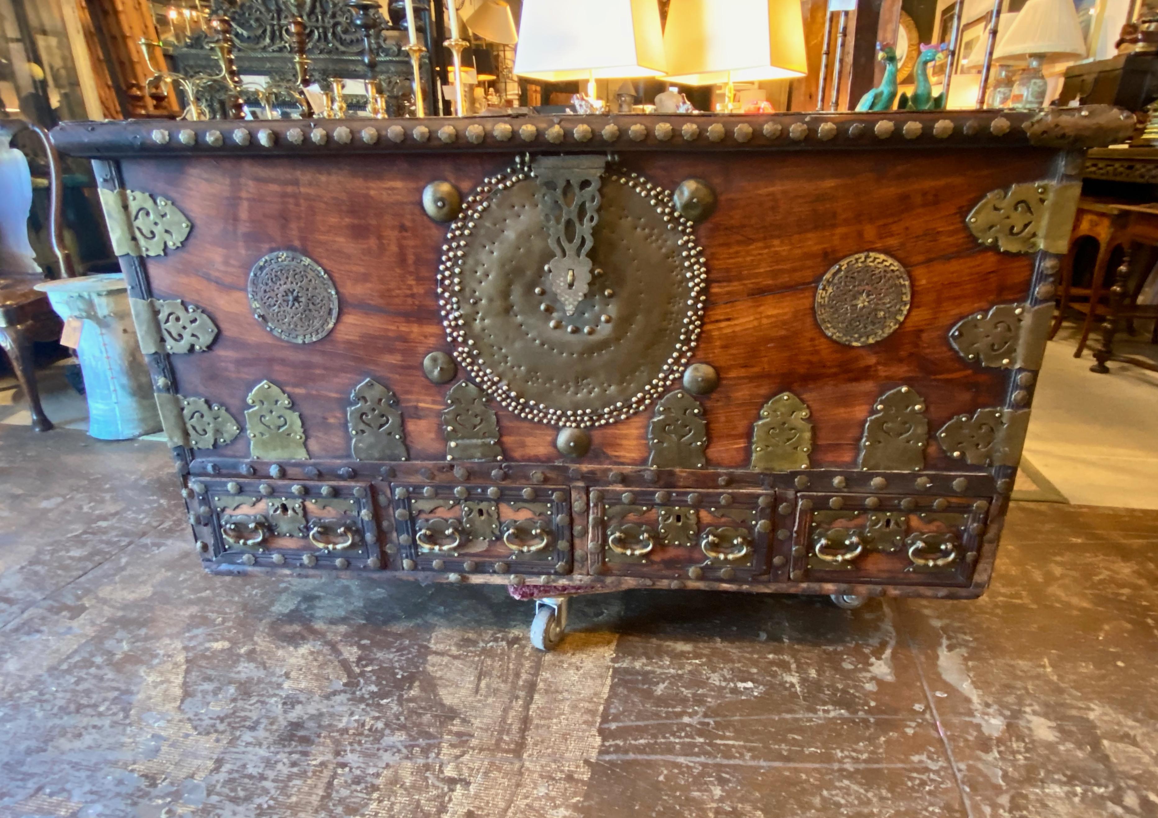 This is a very good example of a 19th century Zanzibar storage chest. The chest was created in the mid-19th century. The teak case is adorned with cut and open work brass strapping in addition to nail head decoration. The chest shows a deep natural