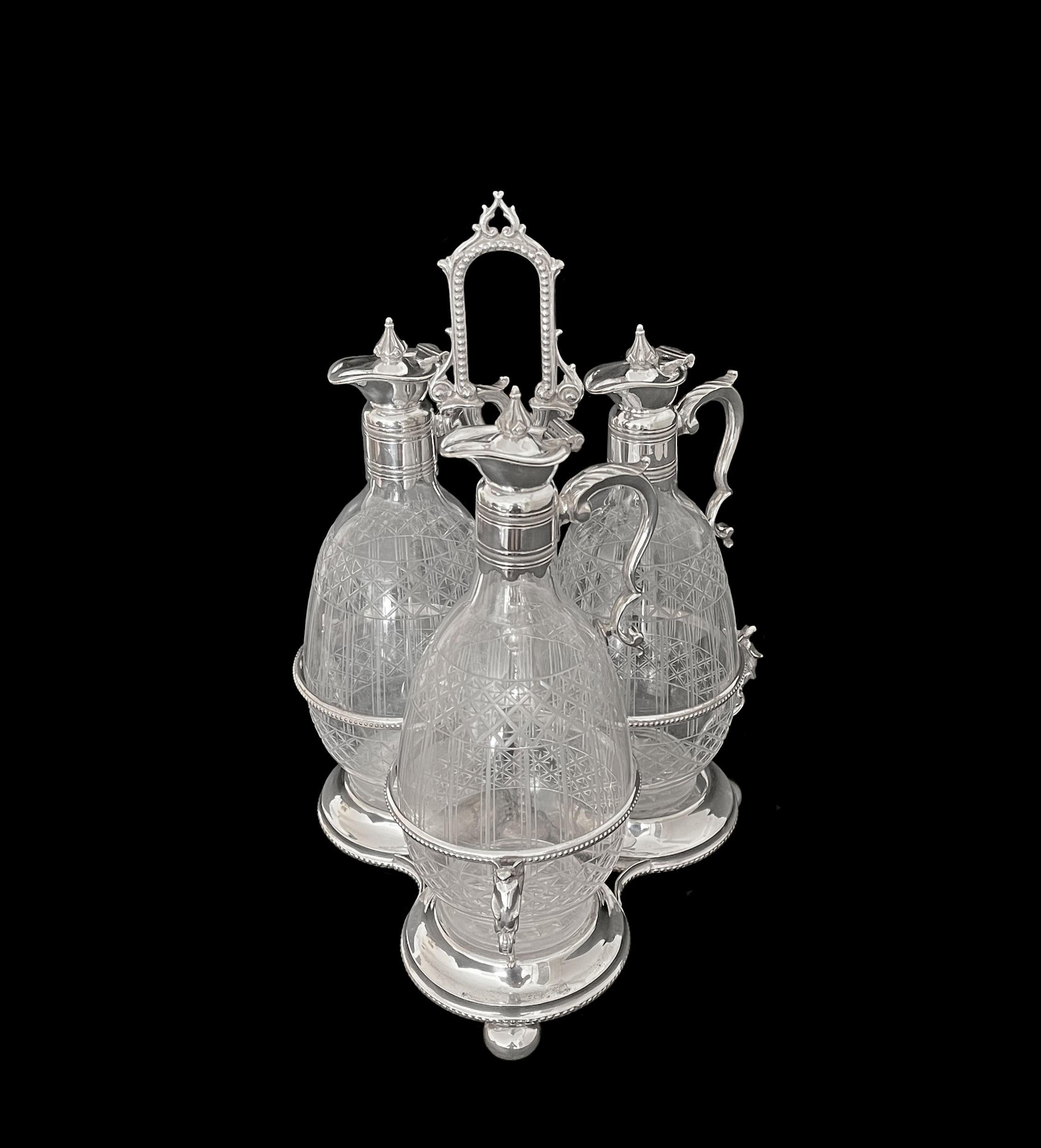 19th C. British cut crystal mounted silver plated cruet set. Three well detailed hand cut crystal jugs rest on a beautiful silver plated stand. British silver plate hallmark underneath the stand.

Measures: H: 14”
D: 9”.