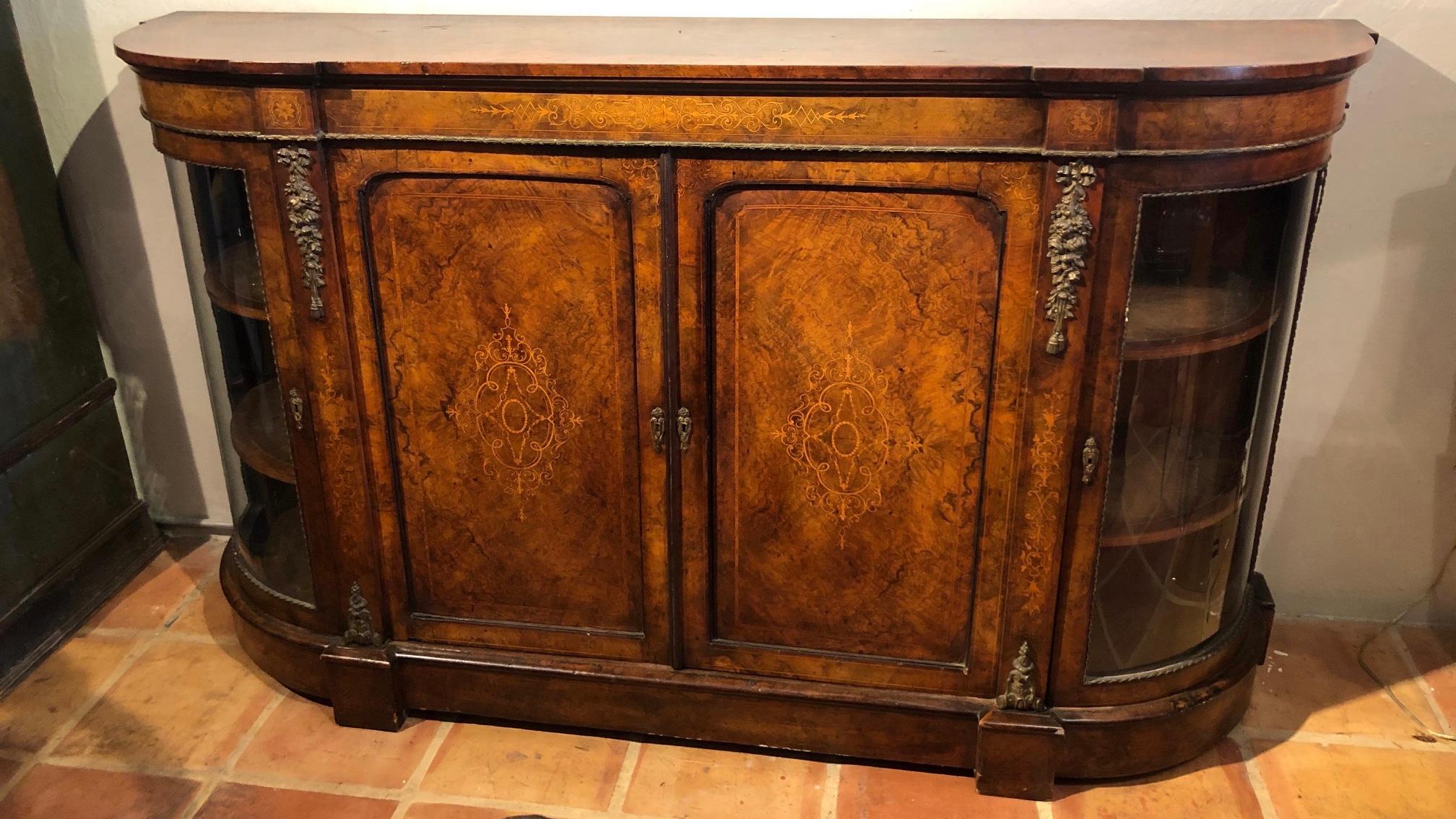 This is a superb traditional mid-19th century. Burr walnut English inlaid and ormolu-mounted credenza
Great quality original patina This credenza is designed with 4 doors.
Its attention to detail and lavish decoration are certain to draw the