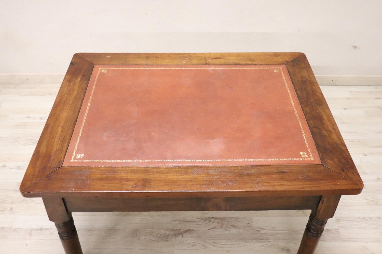 Rare and fine quality Italian antique coffee table or sofa table 1850. The table is in precious cherry wood. characterized by a simple line with turned legs. The top is covered in light brown imitation leather enriched by a border with a classic