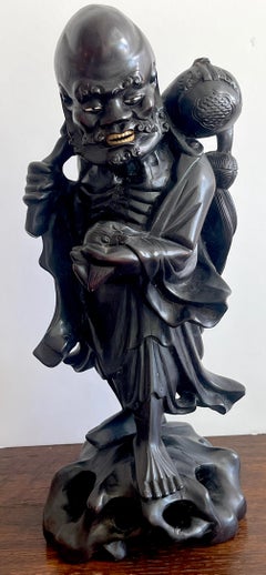19th Chinese Carved Hardwood Figure of an Immortal Holding a Bat