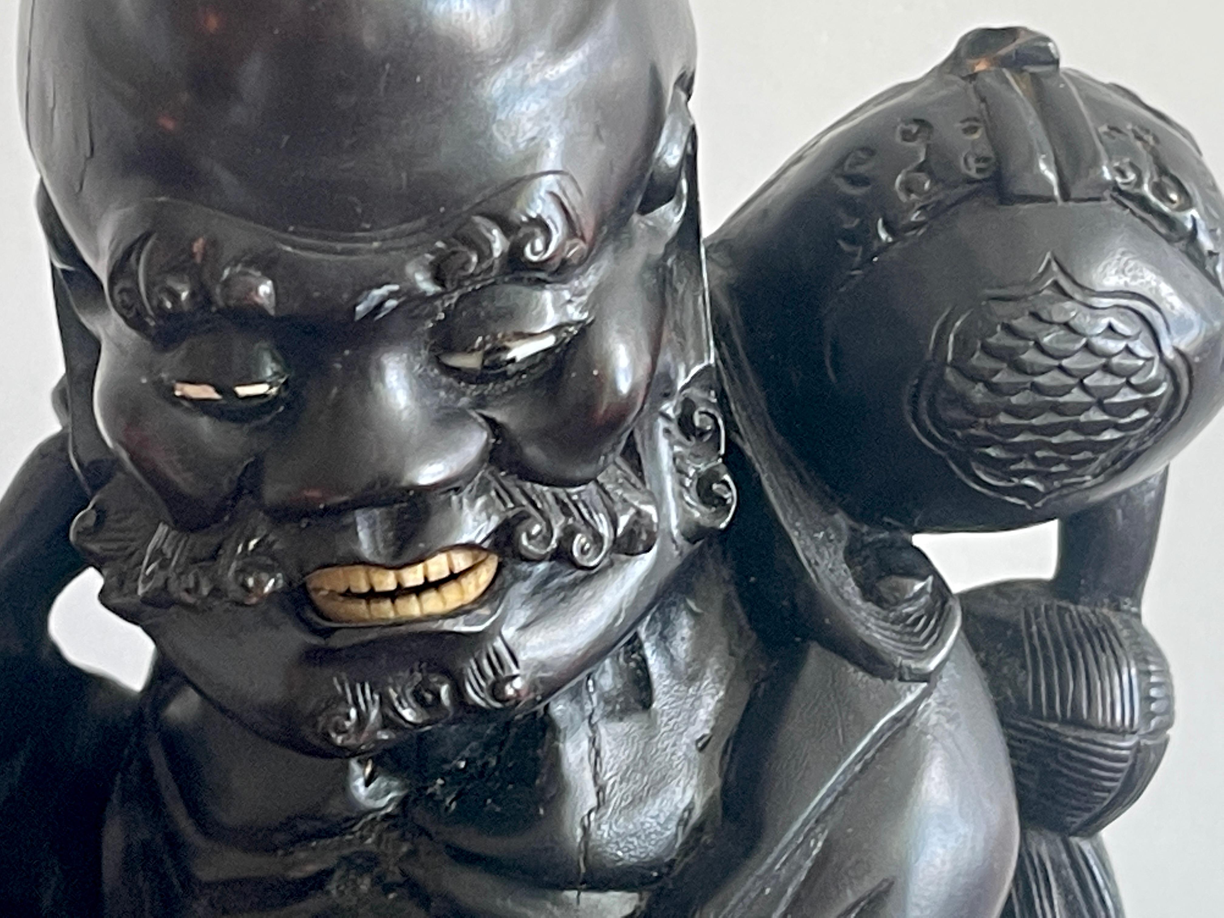 Chinese Export 19th Chinese Carved Hardwood Figure of an Immortal Holding a Bat For Sale