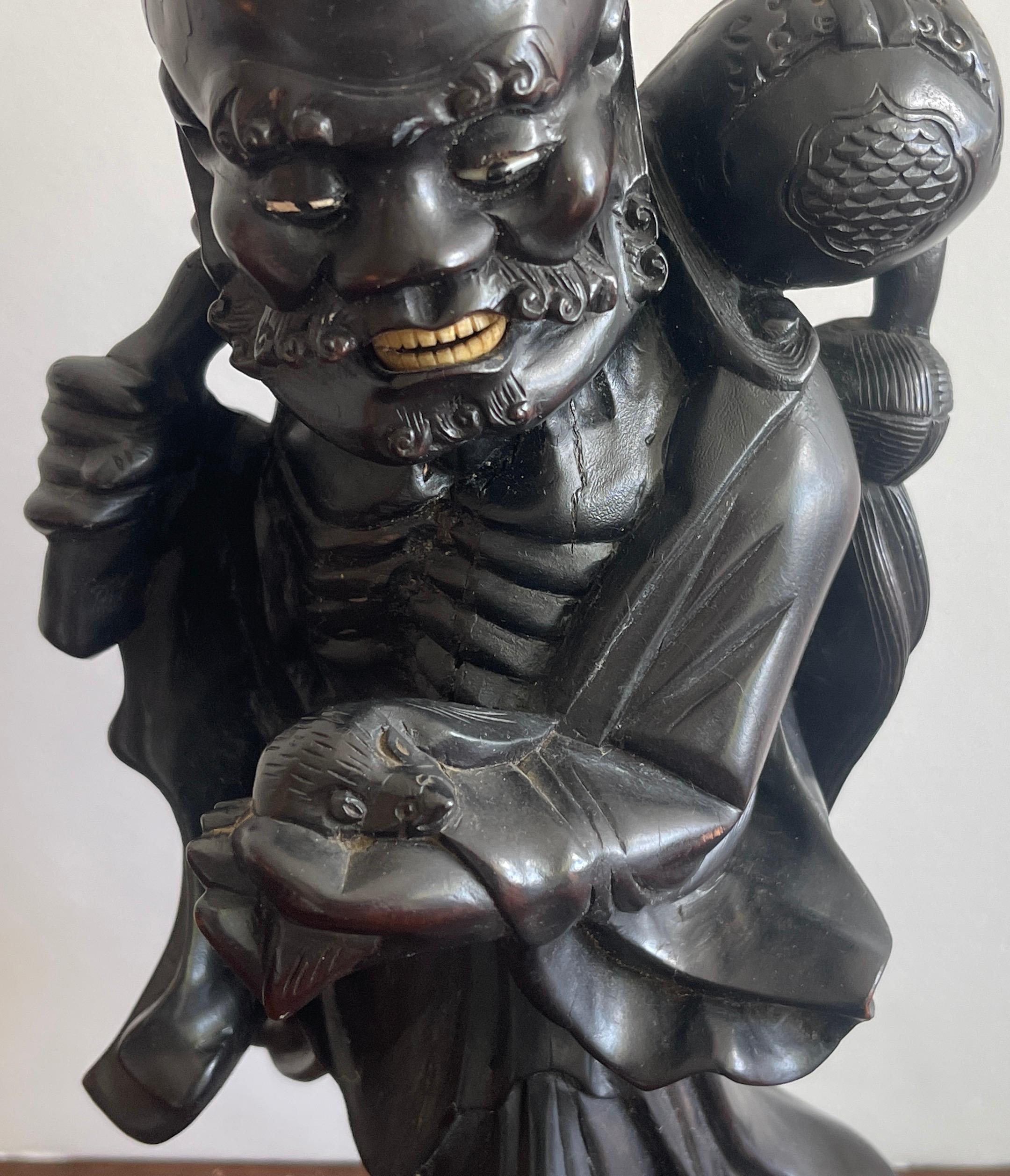 Hand-Carved 19th Chinese Carved Hardwood Figure of an Immortal Holding a Bat For Sale