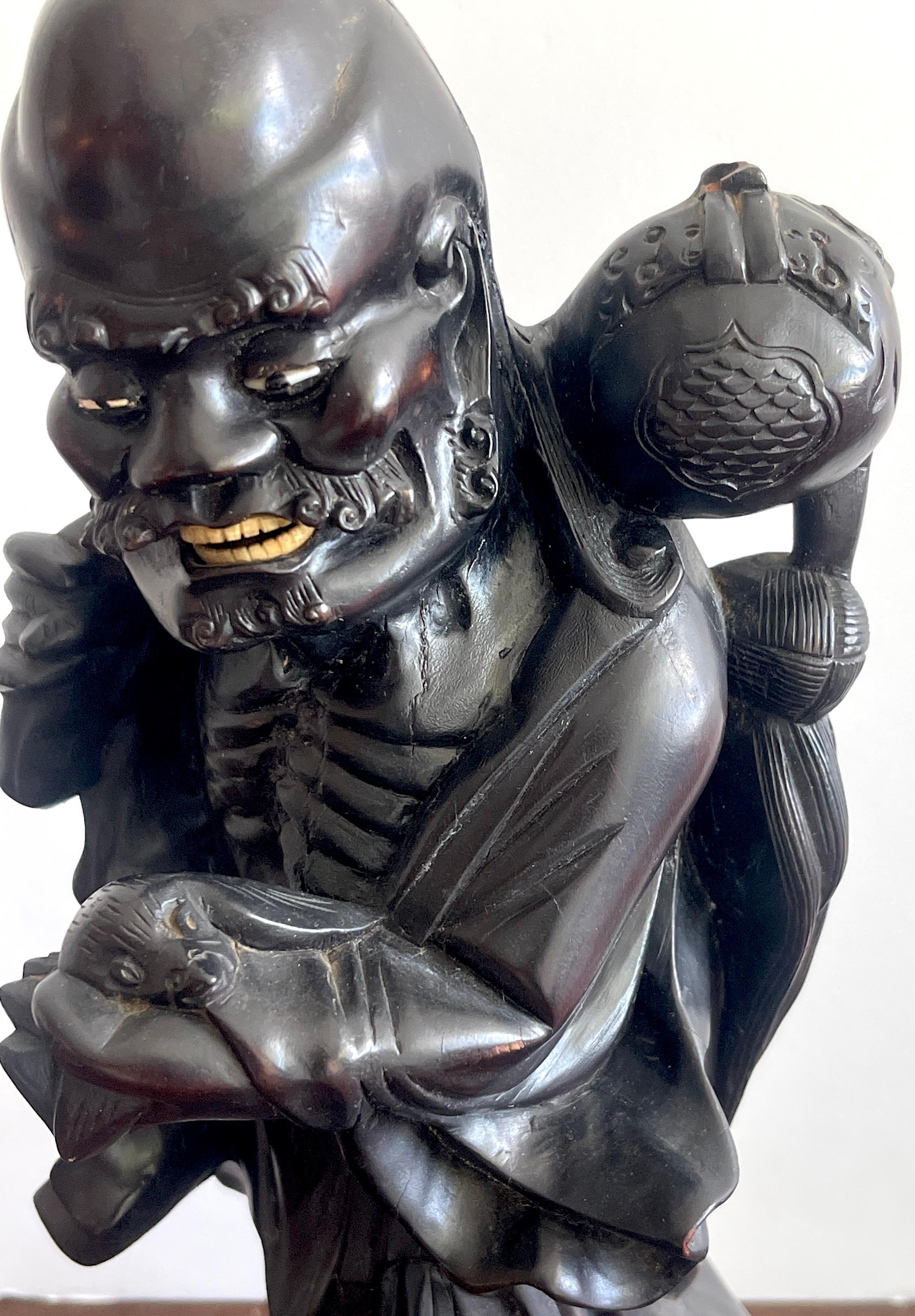 19th Chinese Carved Hardwood Figure of an Immortal Holding a Bat In Good Condition For Sale In West Palm Beach, FL