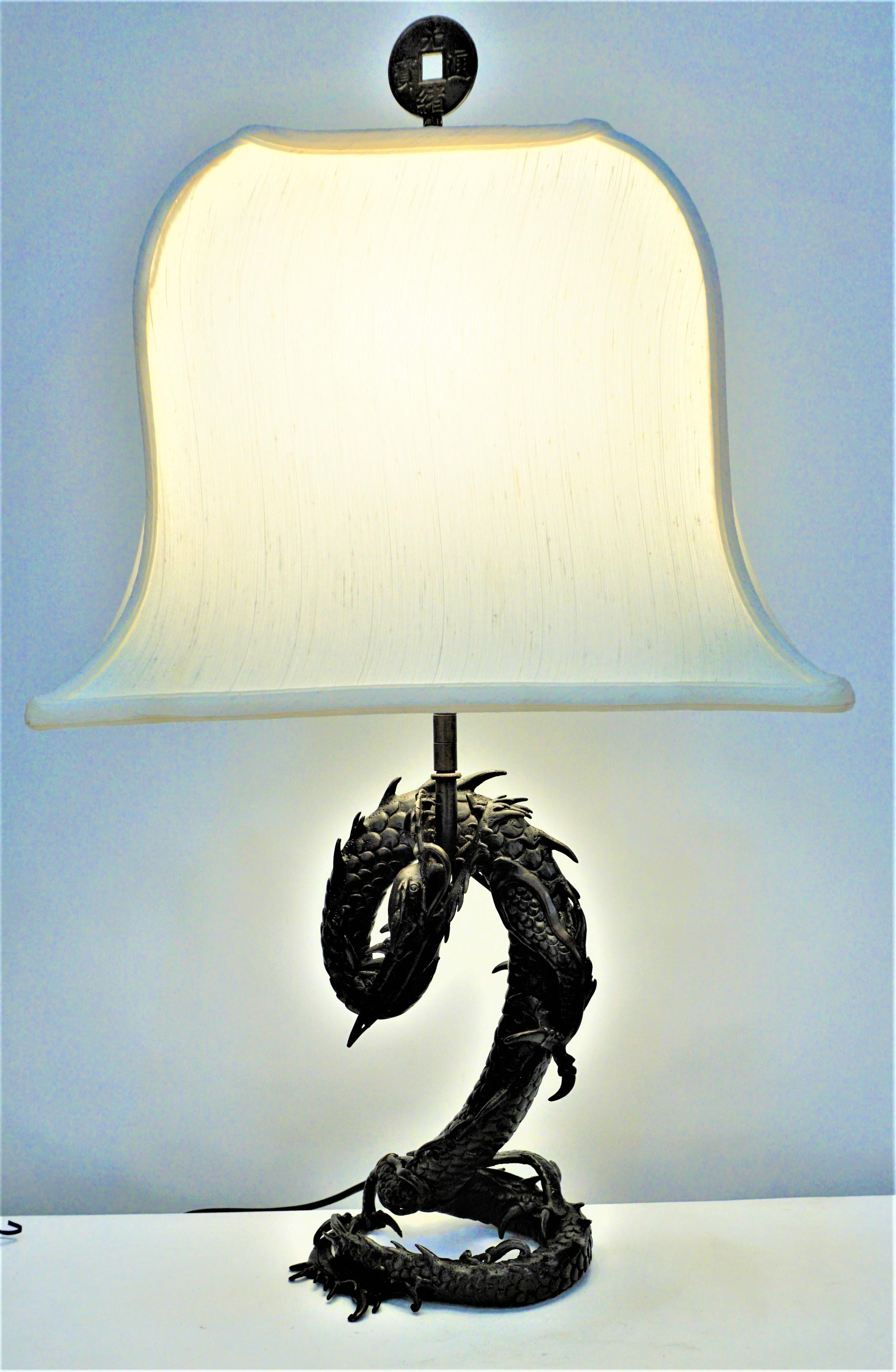 19th century Chinese bronze dragon that has been electrified as table lamp and fitted with bell pagoda lampshade.
Measurement includes the shade.