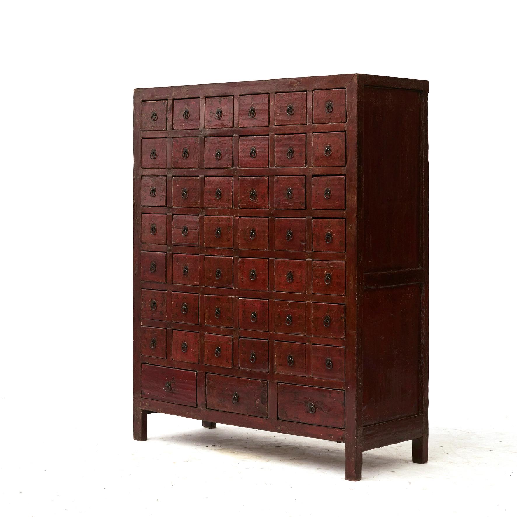 A Chinese Qing Dynasty apothecary / pharmacy medicine chest.
Front in original red lacquer with 45 drawers (42 small drawers + 3 larger drawers at the bottom).
Each drawer with hand written Chinese calligraphy in black lacquer. These were used to