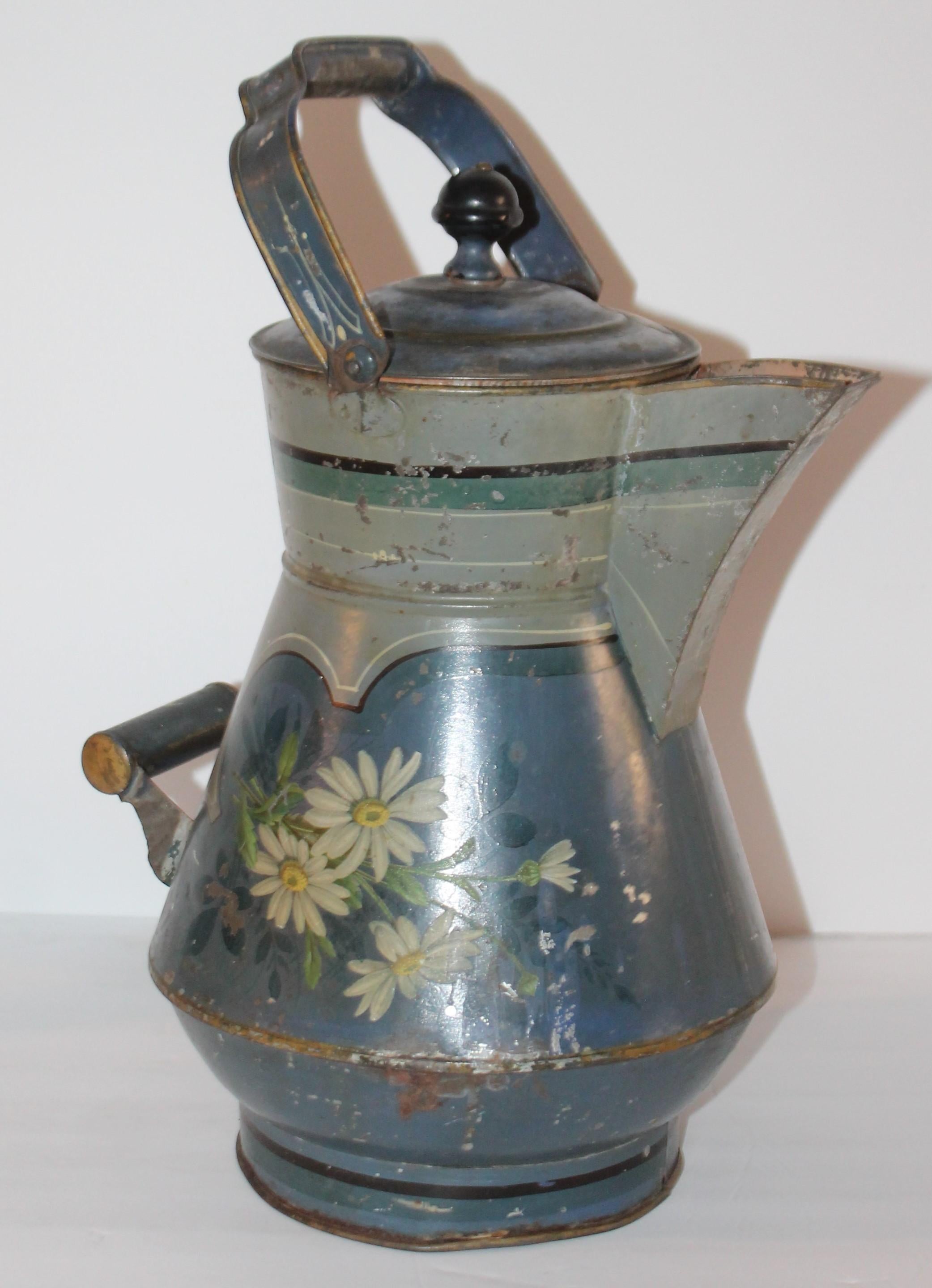 This fantastic tin blue paint decorated tole ware water kettle is in amazing as found condition. It has a blue ground with painted flowers on both sides. The interior is painted in a amazing salmon paint.