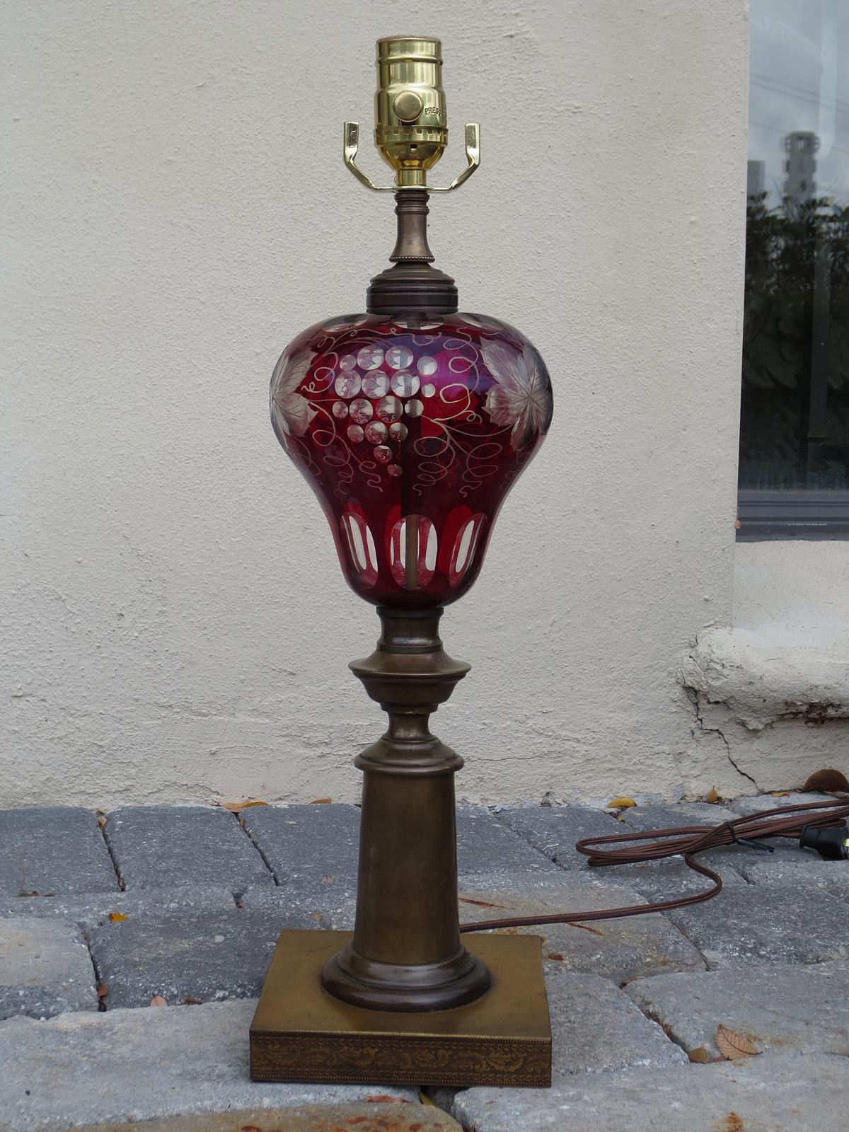 19th-early 20th century red cut to clear glass lamp on bronze base.
New wiring.