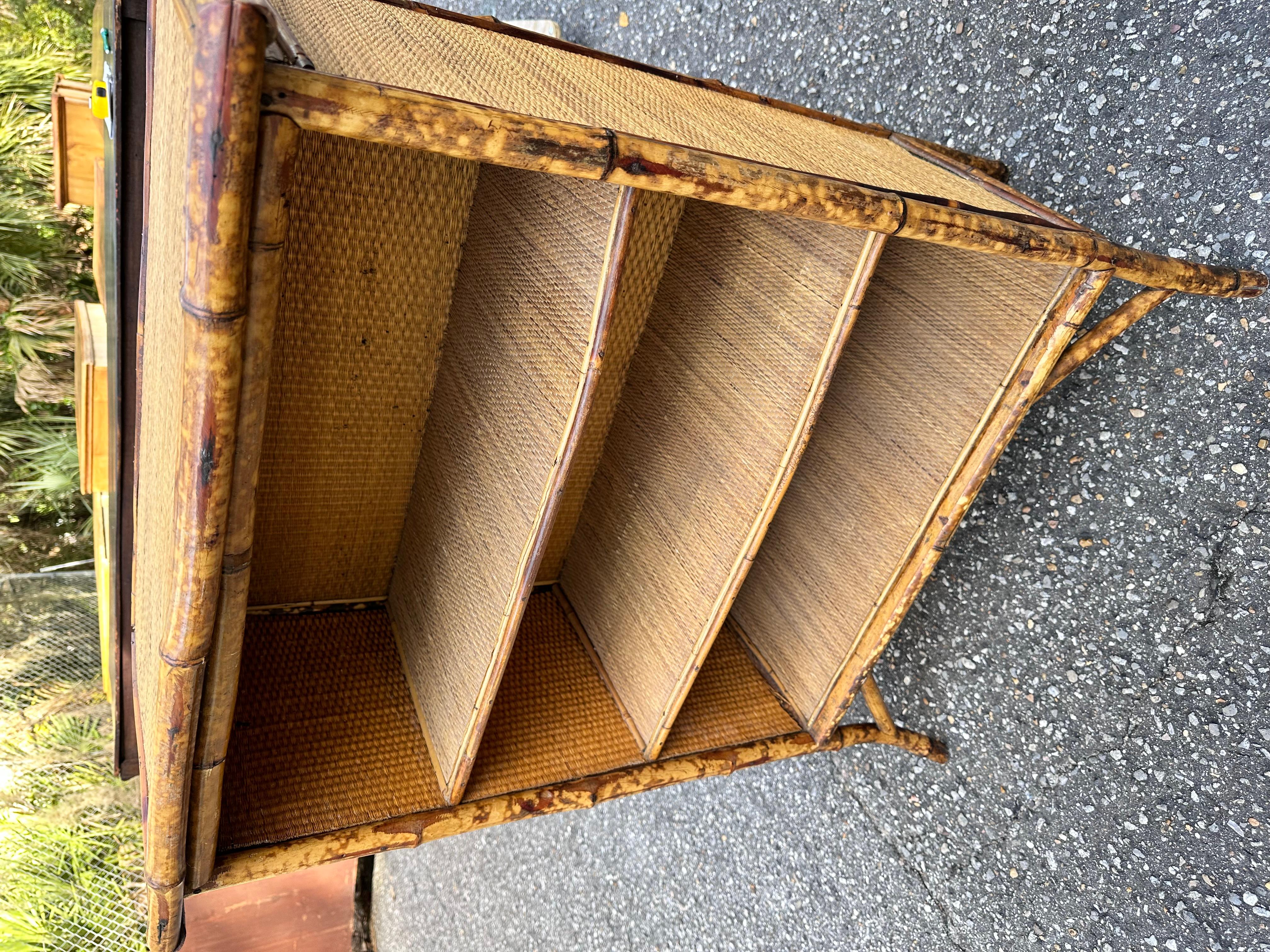 This 19th Century English bamboo book case is a lovely find. The shading of this item makes it particularly appealing and easy to mix alongside other wood tones to add variety and depth. Style, shading, and heritage make this is book case a triple