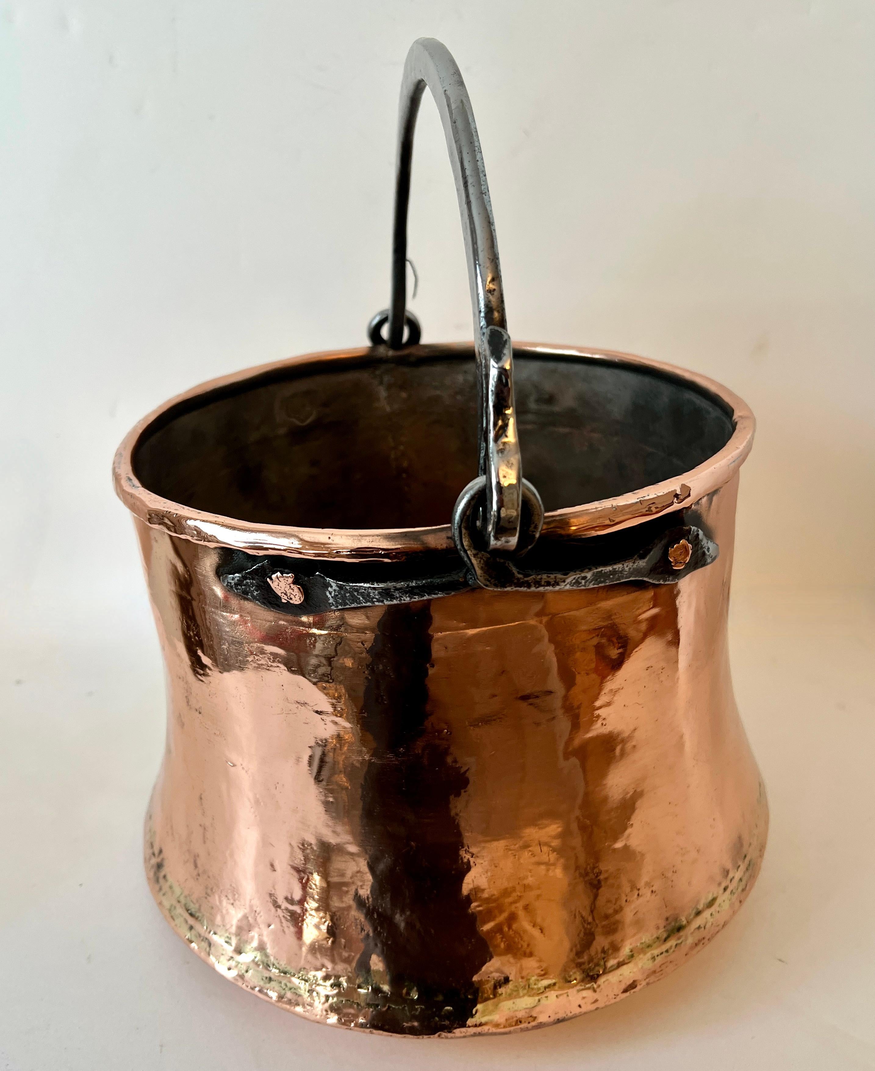 a 19th Century pot, lovely hanging in a decorative kitchen that you never use... a cpmpliment as a jardiniere, centerpiece or planter, inside or out.

Polished to a high gloss that will never tarnish, like the love for this piece.