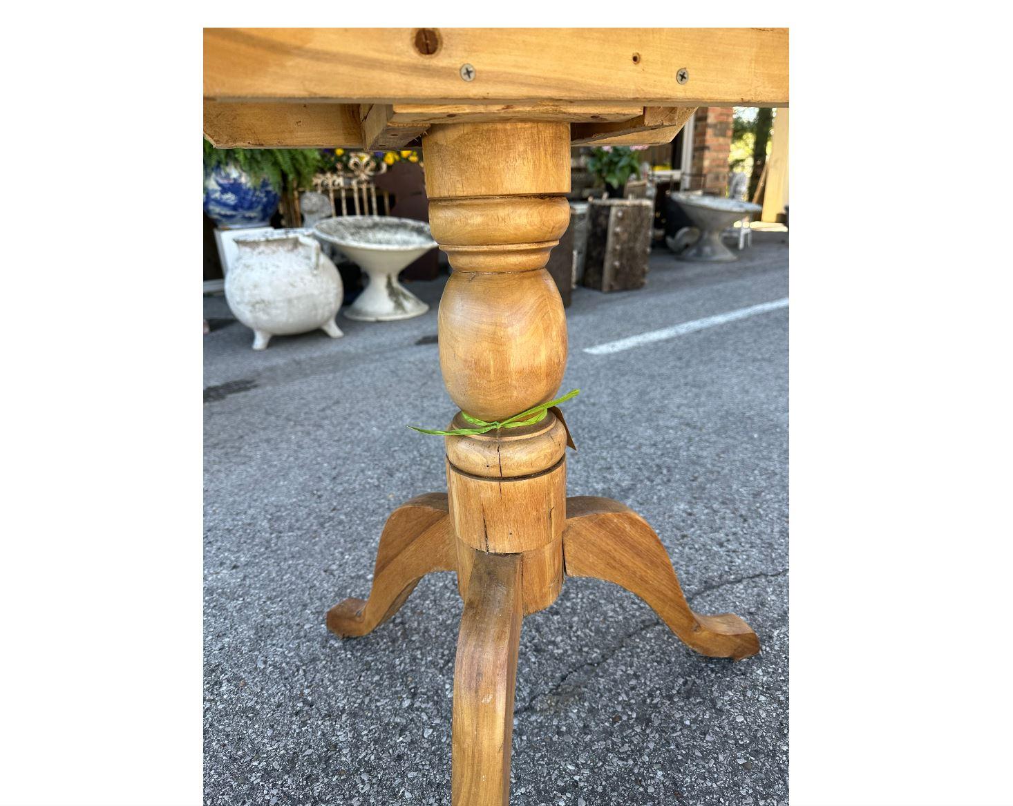 This is beautiful little English pine side table! It has a turned, pedestal design with 3 lovely curved legs. The old English pine gives this piece such a nice warm wood tone. There is lovely natural design in the pine top as well! Versatile enough