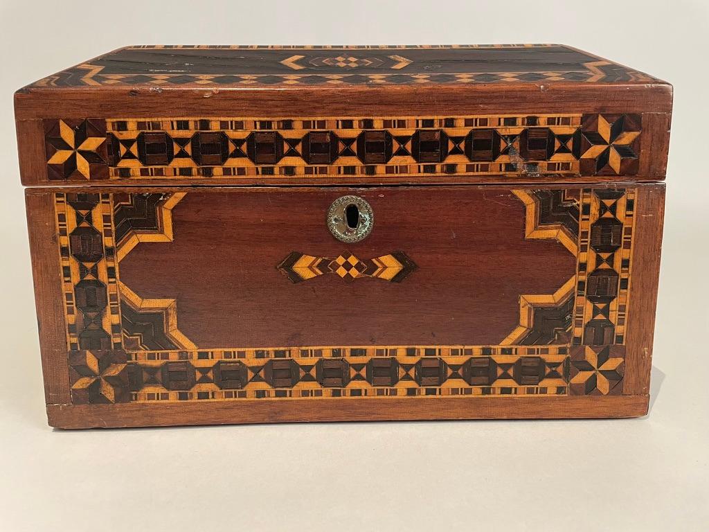 19th century Regency jewelry bow with exquisite inlay of various woods, ebony, rosewood, fruit wood, walnut, mahogany. With intricate geometric pattern inlay throughout and start patterns in the corners. Lovely shaped top, inner tray that lifts out.