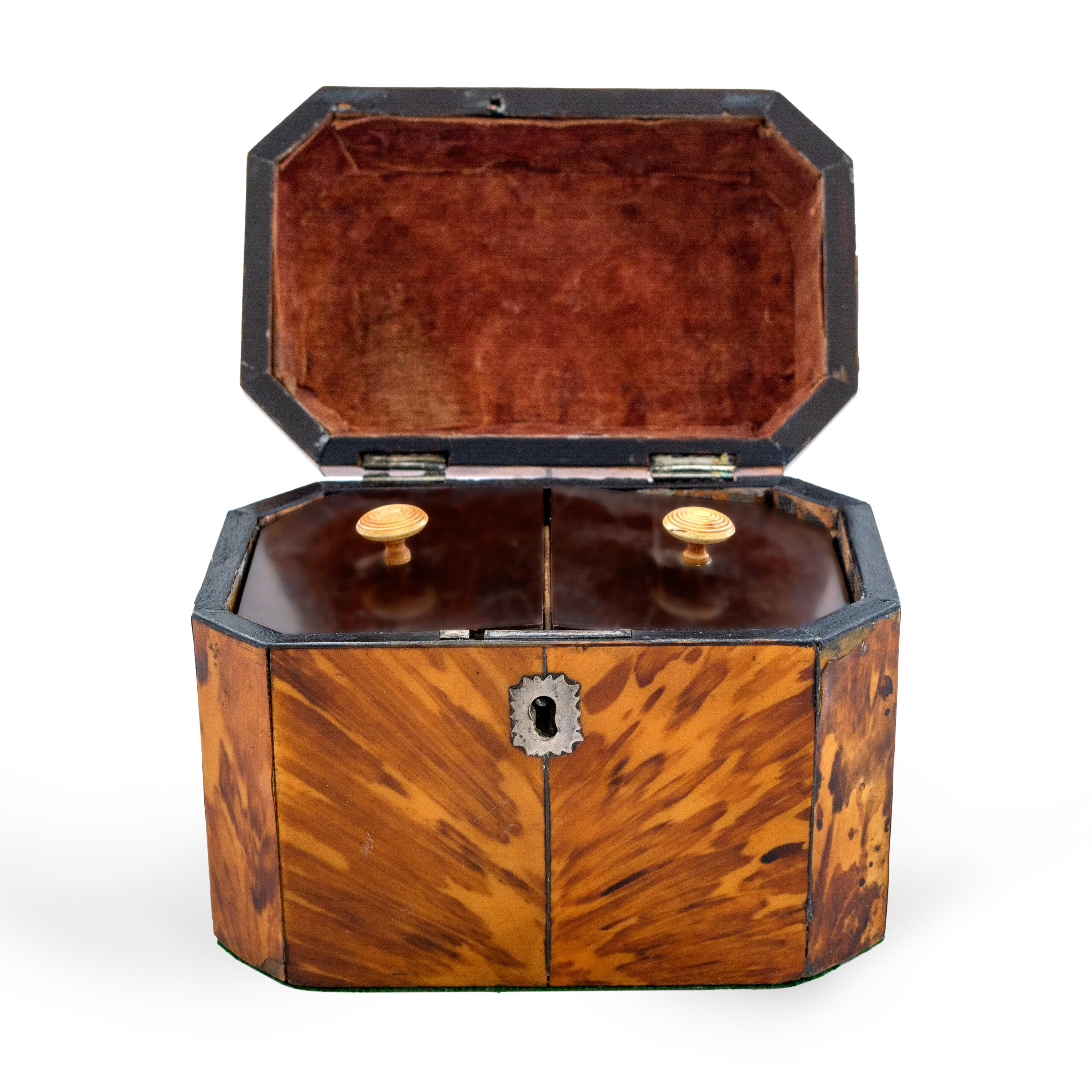 This is a classic English Regency tea caddy, veneered with tortoise-shell, the front with canted corners. The lid opens to reveal two lidded compartments, 19th century.