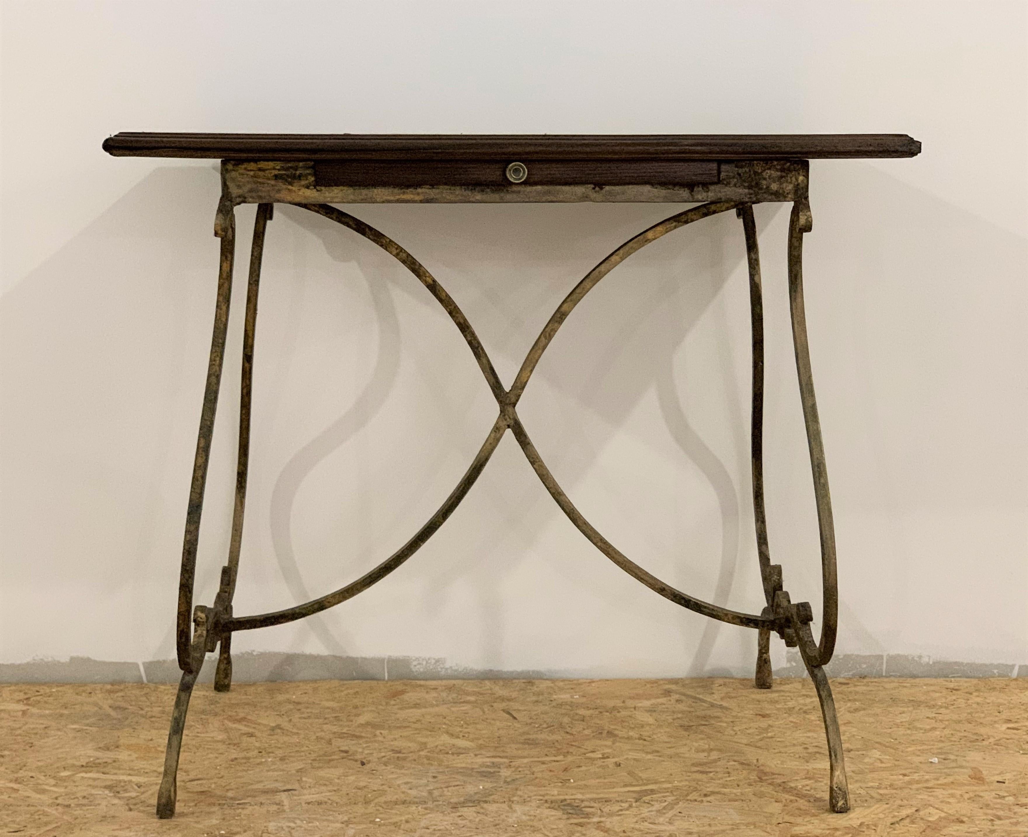 19th century French bistro table with iron lyre legs & wood top with drawer
Really chic and beautiful
Original patina
Restored top.
  