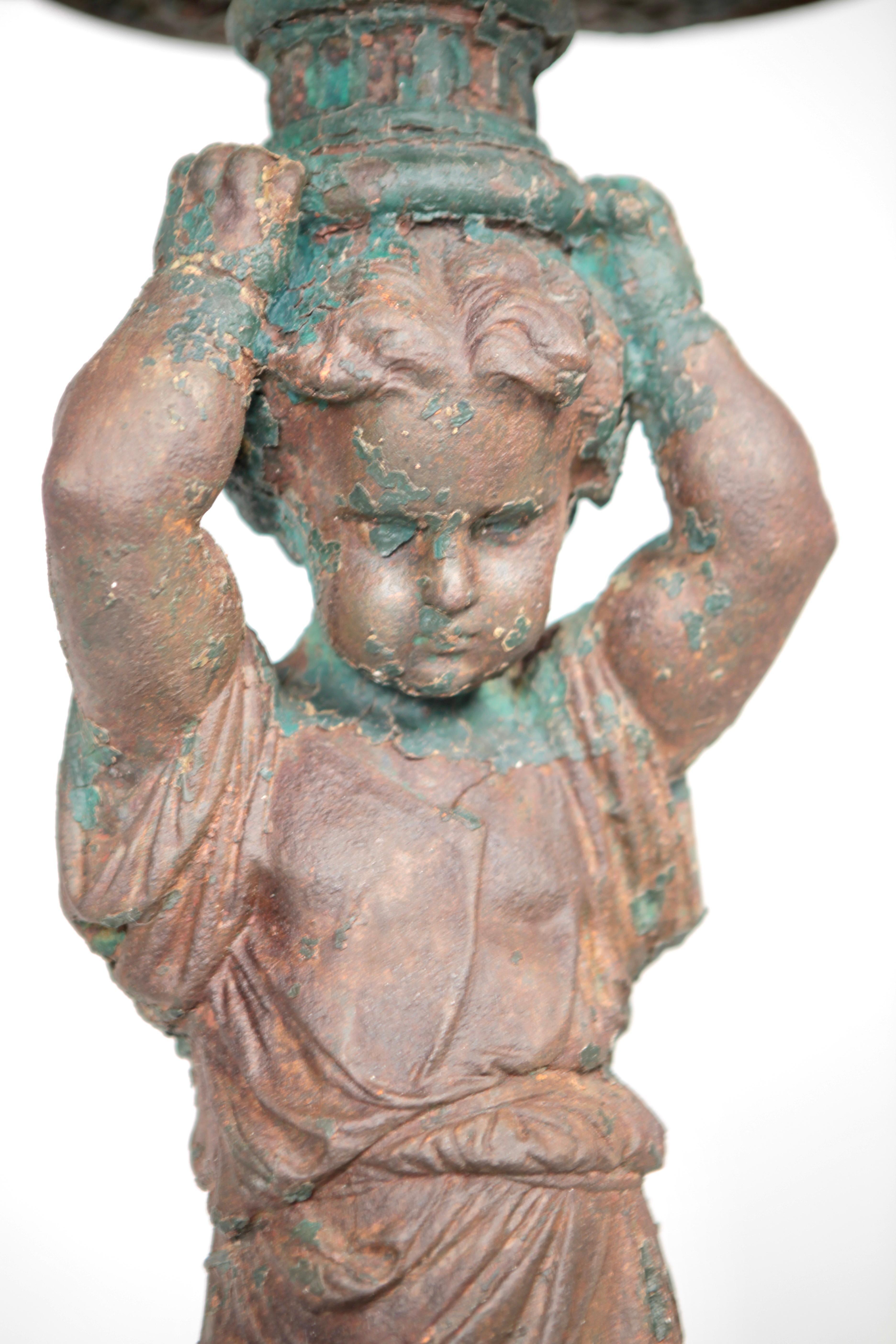 This 19th century antique cast iron statue fountain.
Fantastic, vibrant patina with traces of ancient paint.
