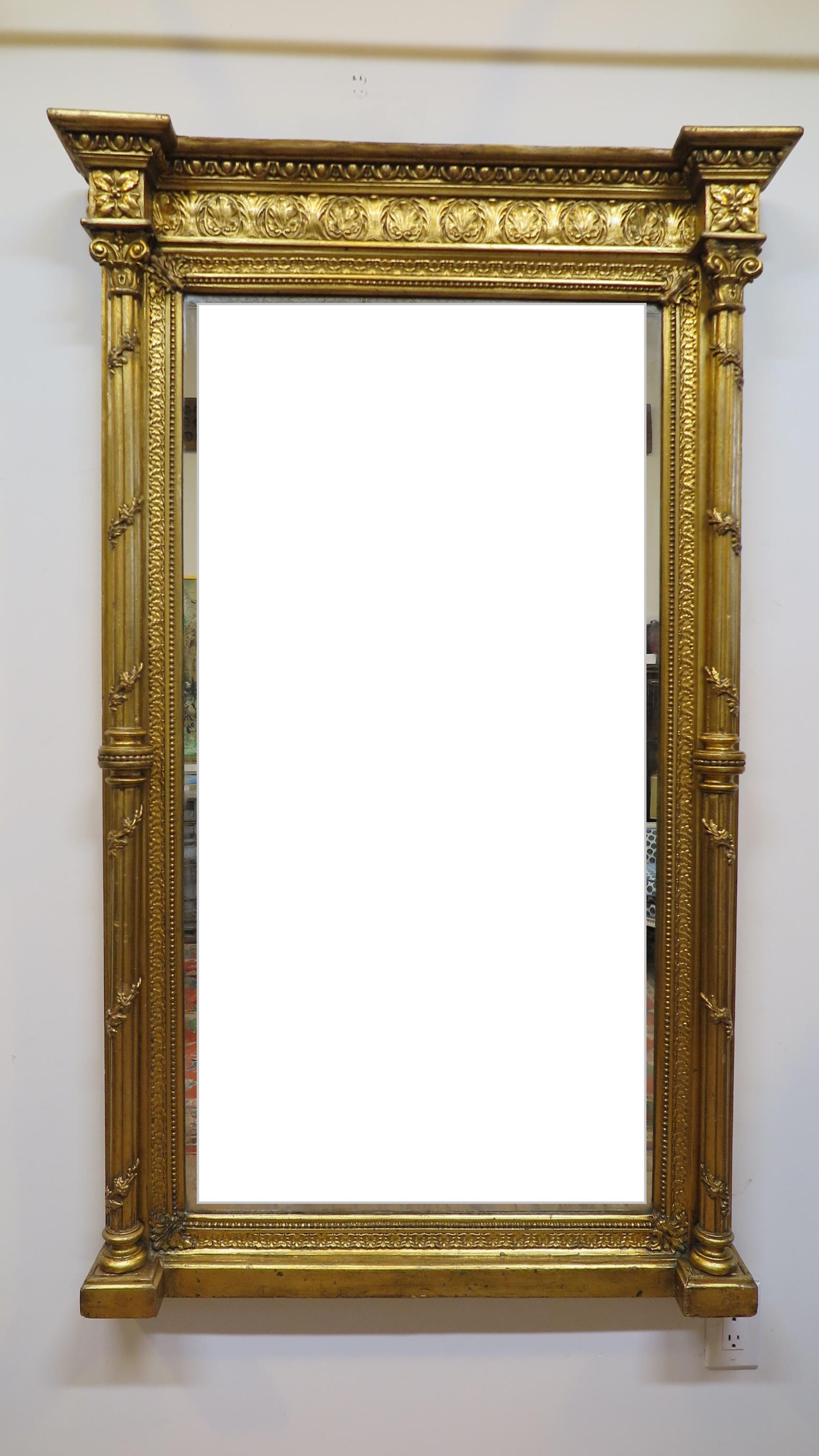 19th century French Empire carved gilt mirror. Corinthian columns with scroll vines flank the sides with leaf medallion motif across the top. Original glass with some touch up to the gilding. Good overall condition. Beautiful gilding work. France,