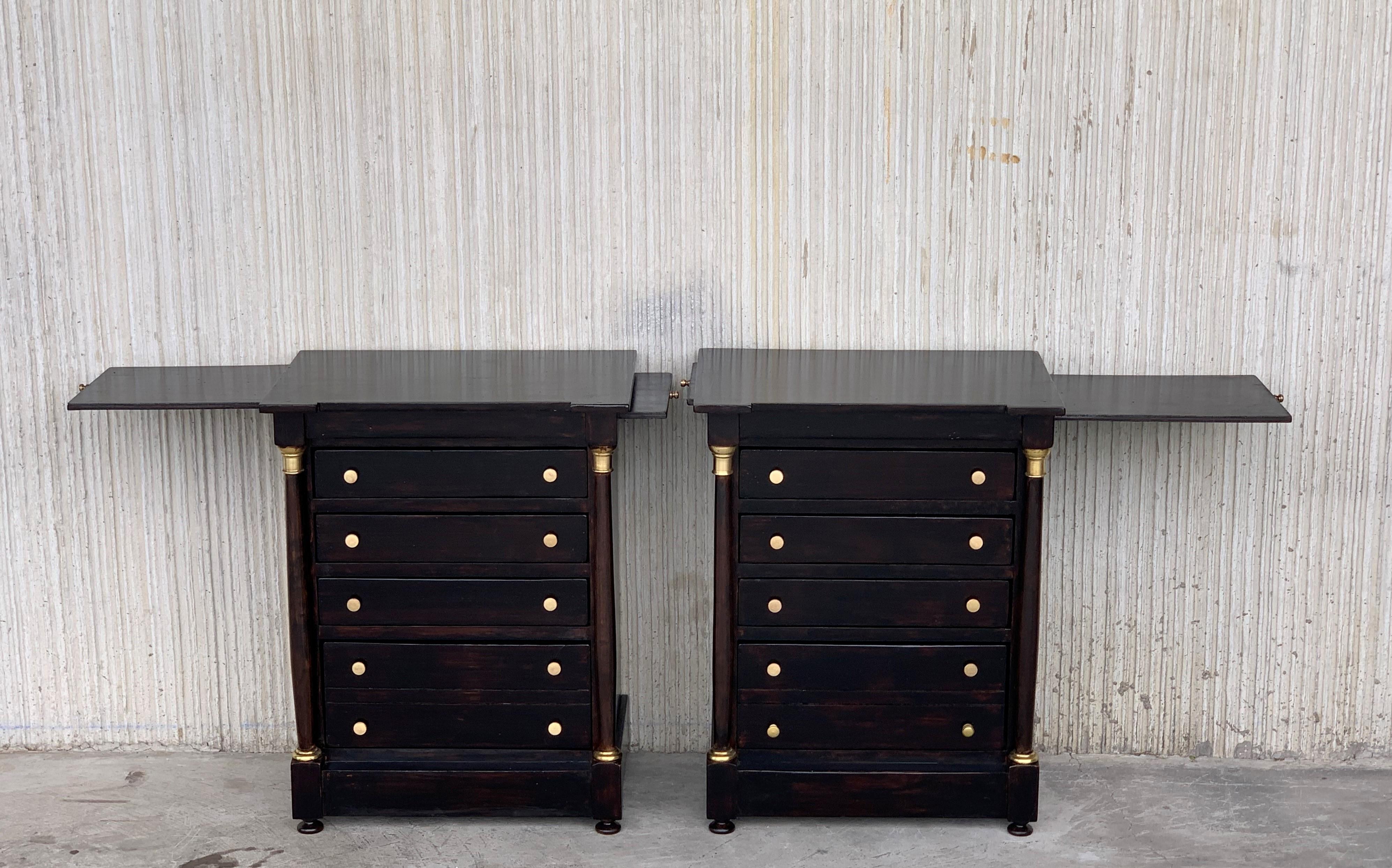 19th century French Louis XVI black ebonized nightstands or side table with four drawers and columns in the sides.
The tables have two hidden trays in both sides for more uses.