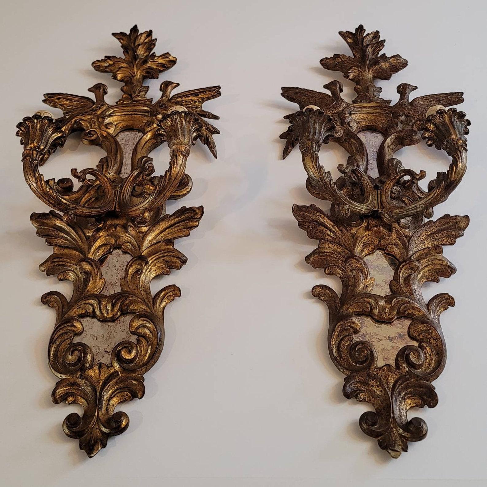 An exceptional pair of elegant French antique, circa 1880, hand carved and gilded two light wall sconces with beautiful patina. 

Born in France in the late 19th century, exquisitely crafted in classical Louis XVI style, originally designed for