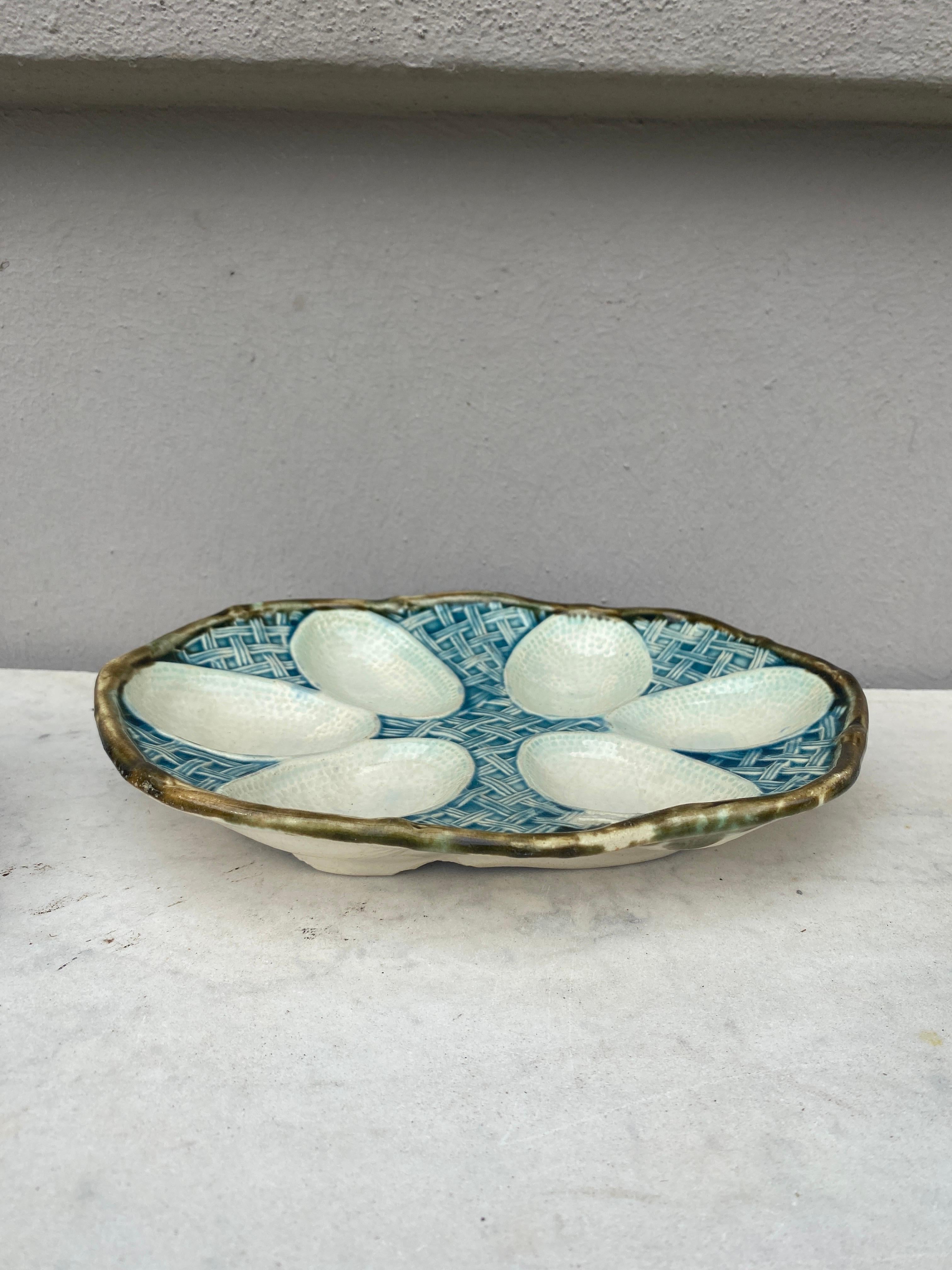 Antique French Majolica oval egg plate circa 1890.
6 eggs on a baby blue basketweave background.
Chips on the back of the plate.