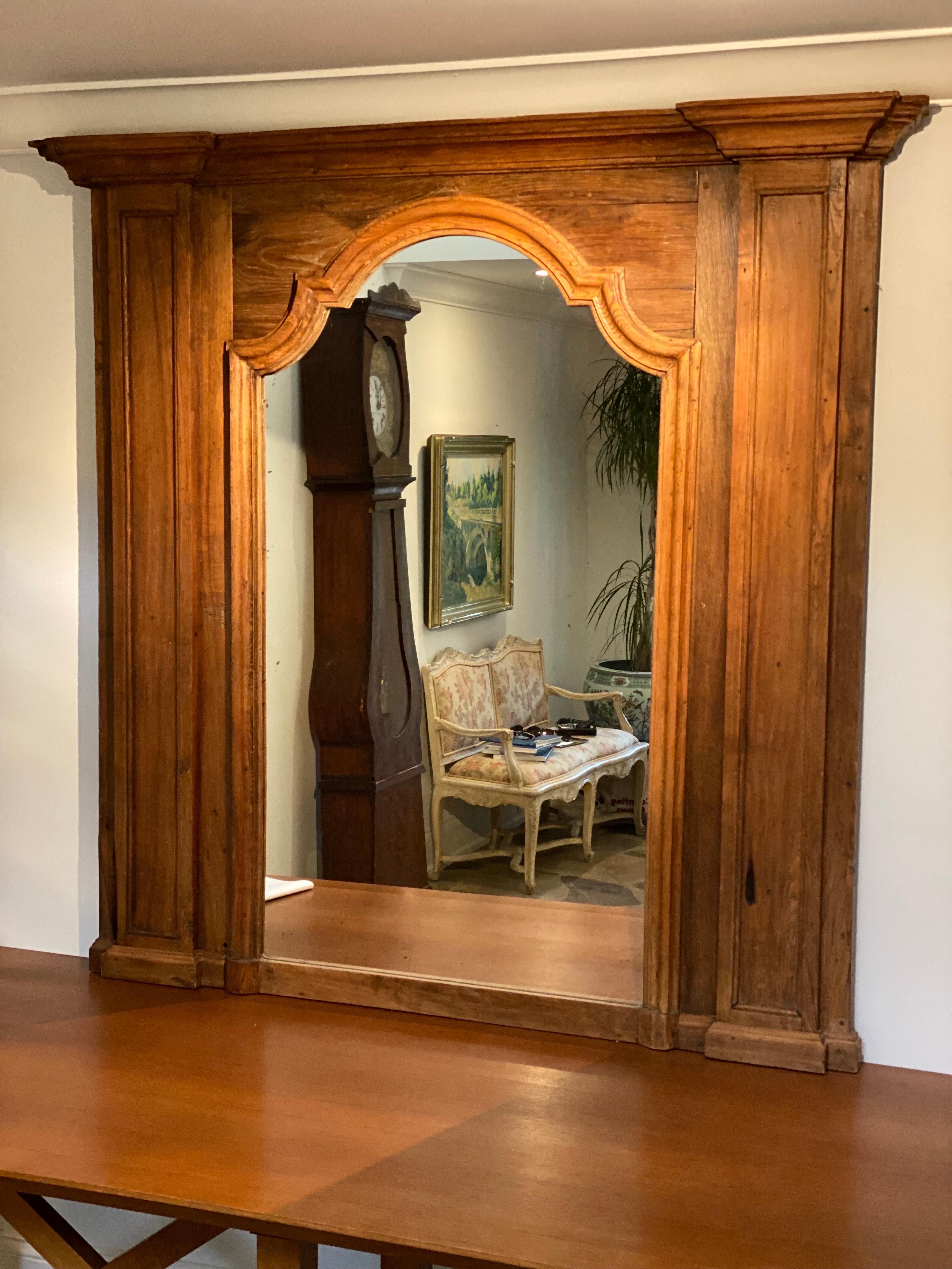 A stunning 19th French Provincial Oak Mantel Mirror purchased from Amy Perlin Antiques in NYC and held in a private collection in Bridgehampton.  A nice aged oak patina. The mirror is meant to sit on a mantel or table but could be hung without. Good